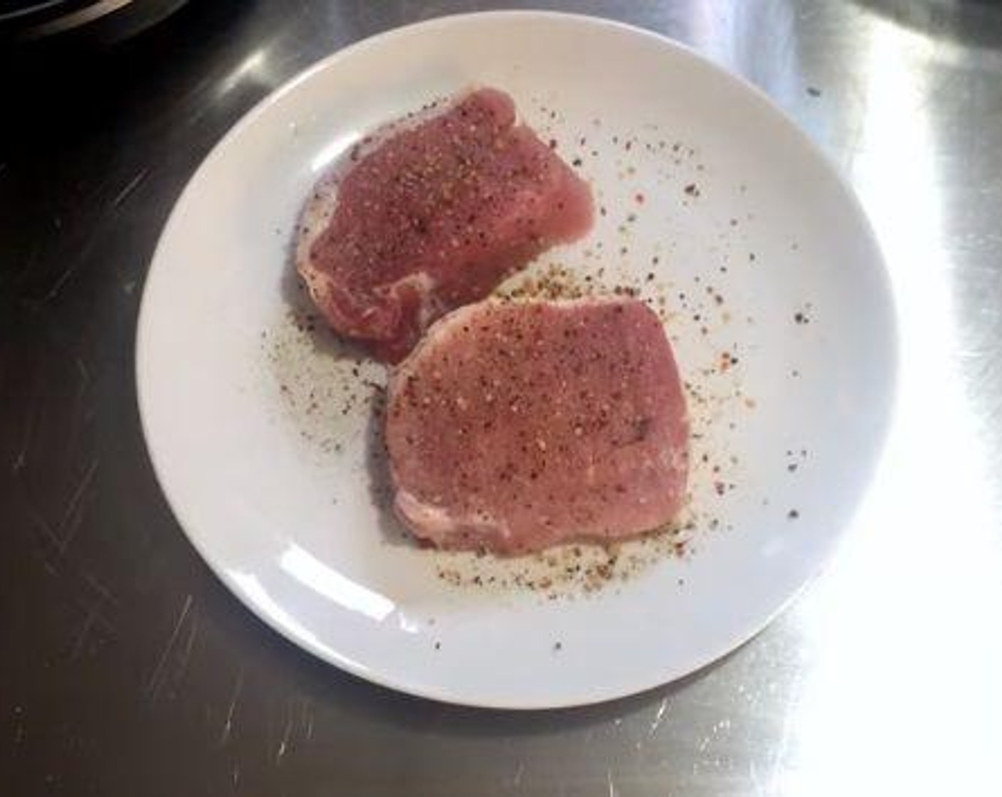 step 2 Season your Boneless Pork Chops (2) with some Garlic Pepper (1/2 Tbsp).