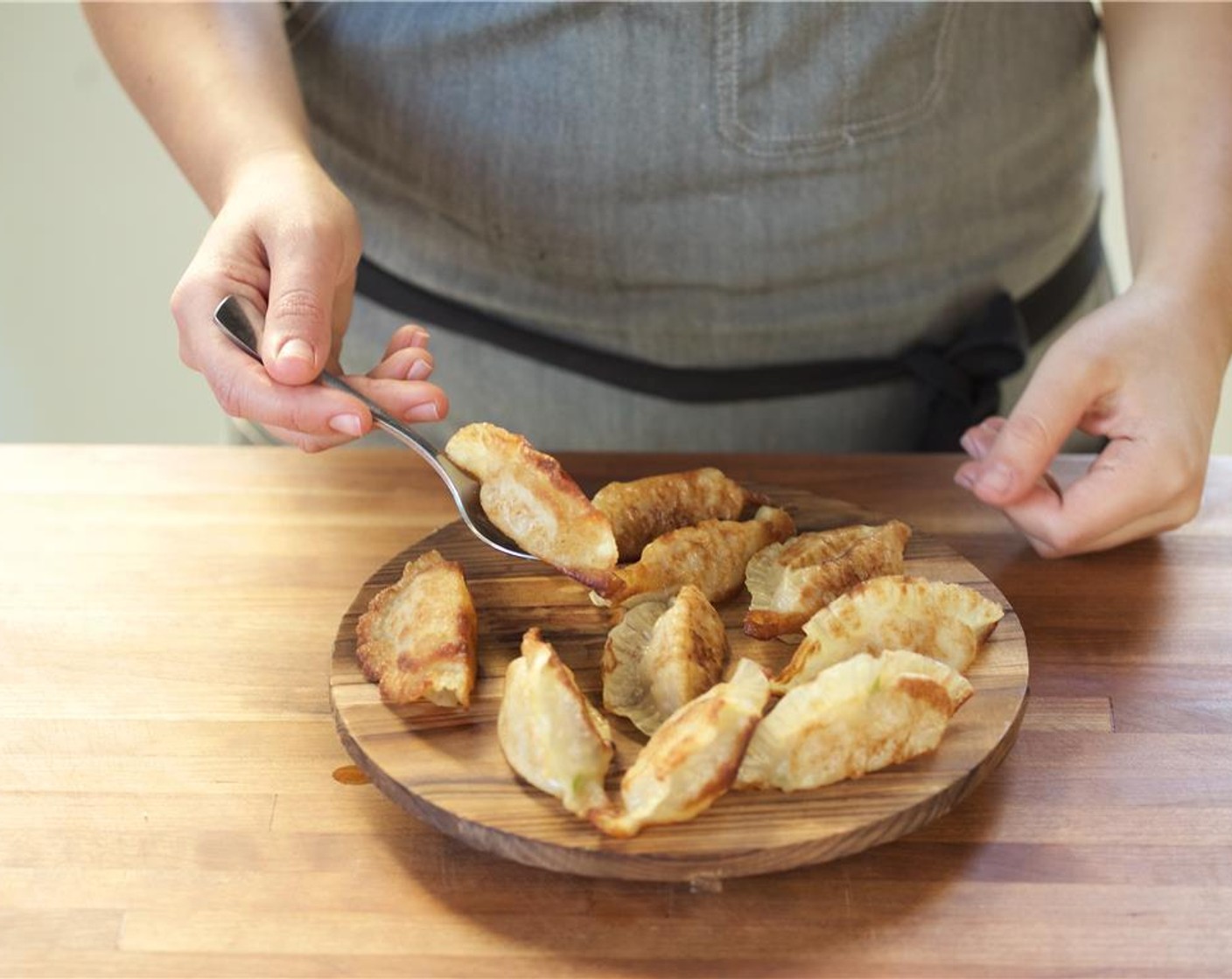 step 14 In the center of two plates, place the dumplings. Place the cucumber salad and dipping sauce on the side.