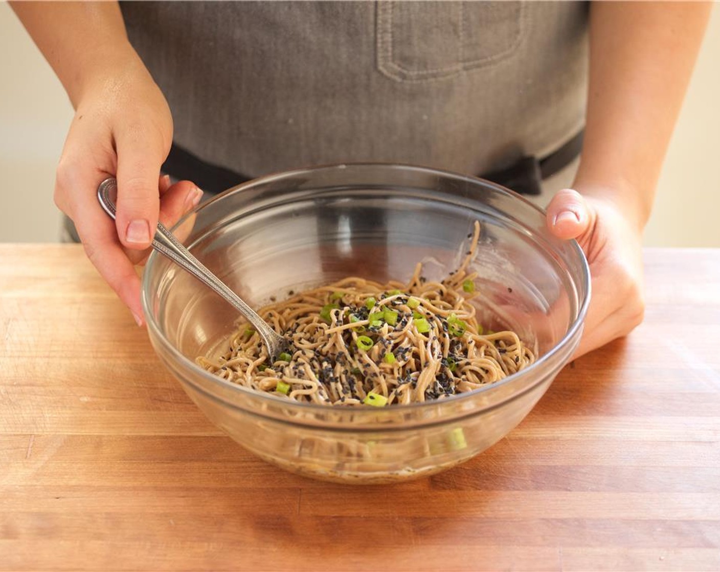 step 7 Once the noodles are cool, toss the noodles with Sesame Oil (1 Tbsp) and scallions.