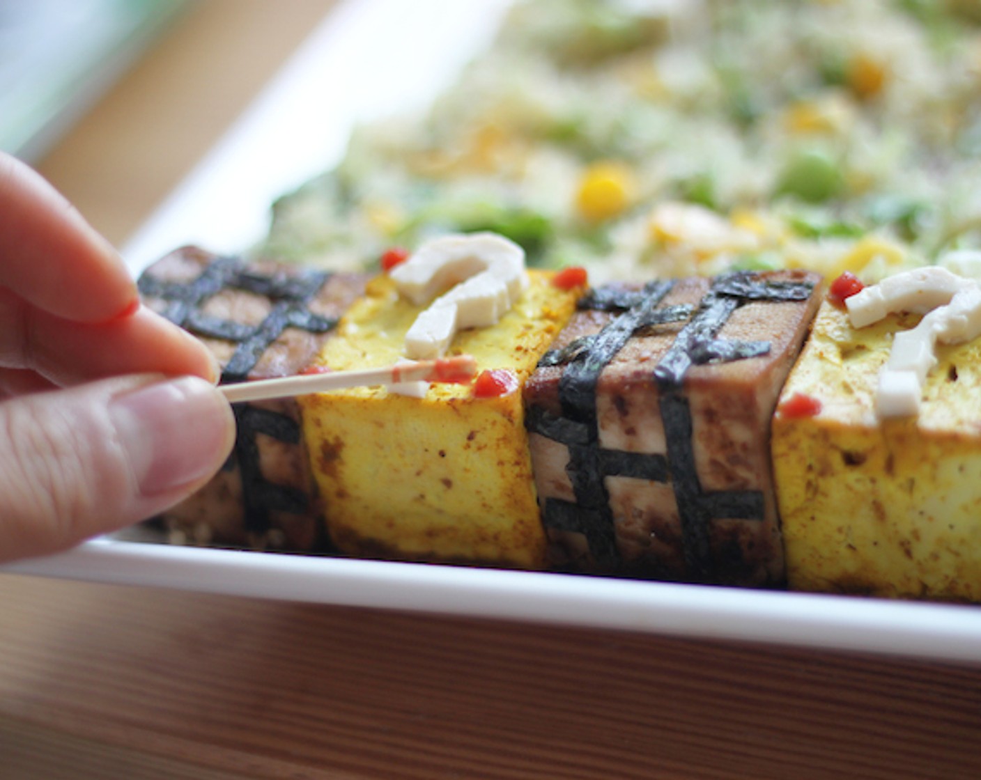 step 14 As for the magic boxes, place question mark-shaped tofu cuts on top of the yellow tofu cubes. Then use a toothpick to put tiny dots of Canned Tomato Purée (1 tsp) on all for corners.