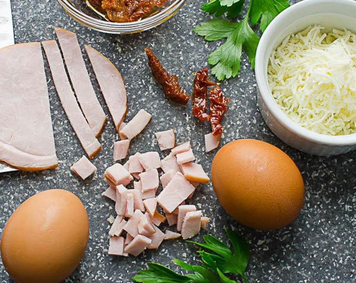 step 2 In a small bowl, combine the Farmhouse Eggs® Large Brown Eggs (3), Kosher Salt (1/4 tsp), Freshly Ground Black Pepper (1/4 tsp), Fresh Parsley (1 tsp), and all but 1 tablespoon of the Shredded Mozzarella Cheese (1/4 cup). Whisk to combine and set aside.