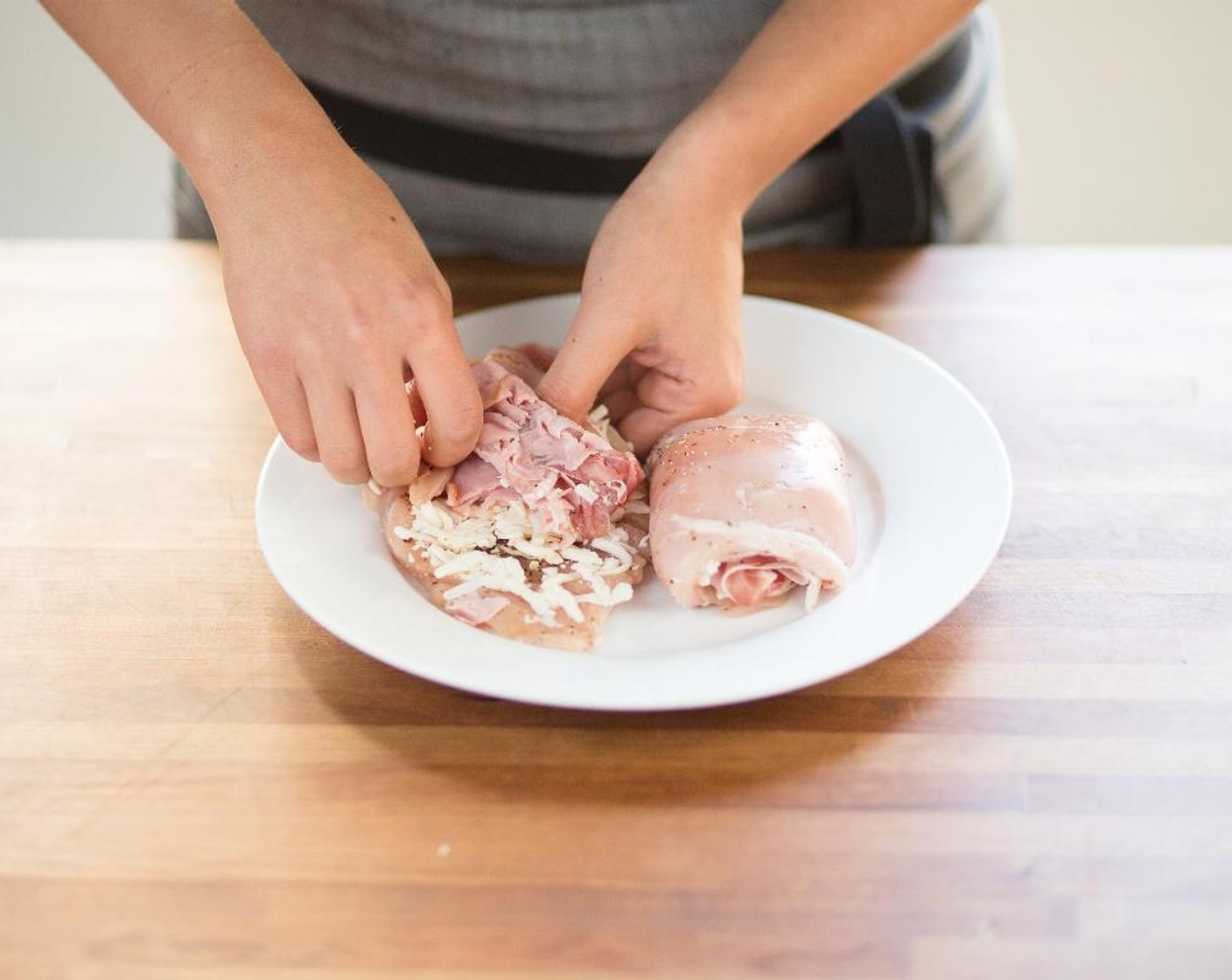 step 5 Lay the chicken breast flat and place Mozzarella Cheese (1 cup), 1 piece of the Smoked Deli Ham (2 slices) and 2 pieces of the Prosciutto (3 oz) on top.