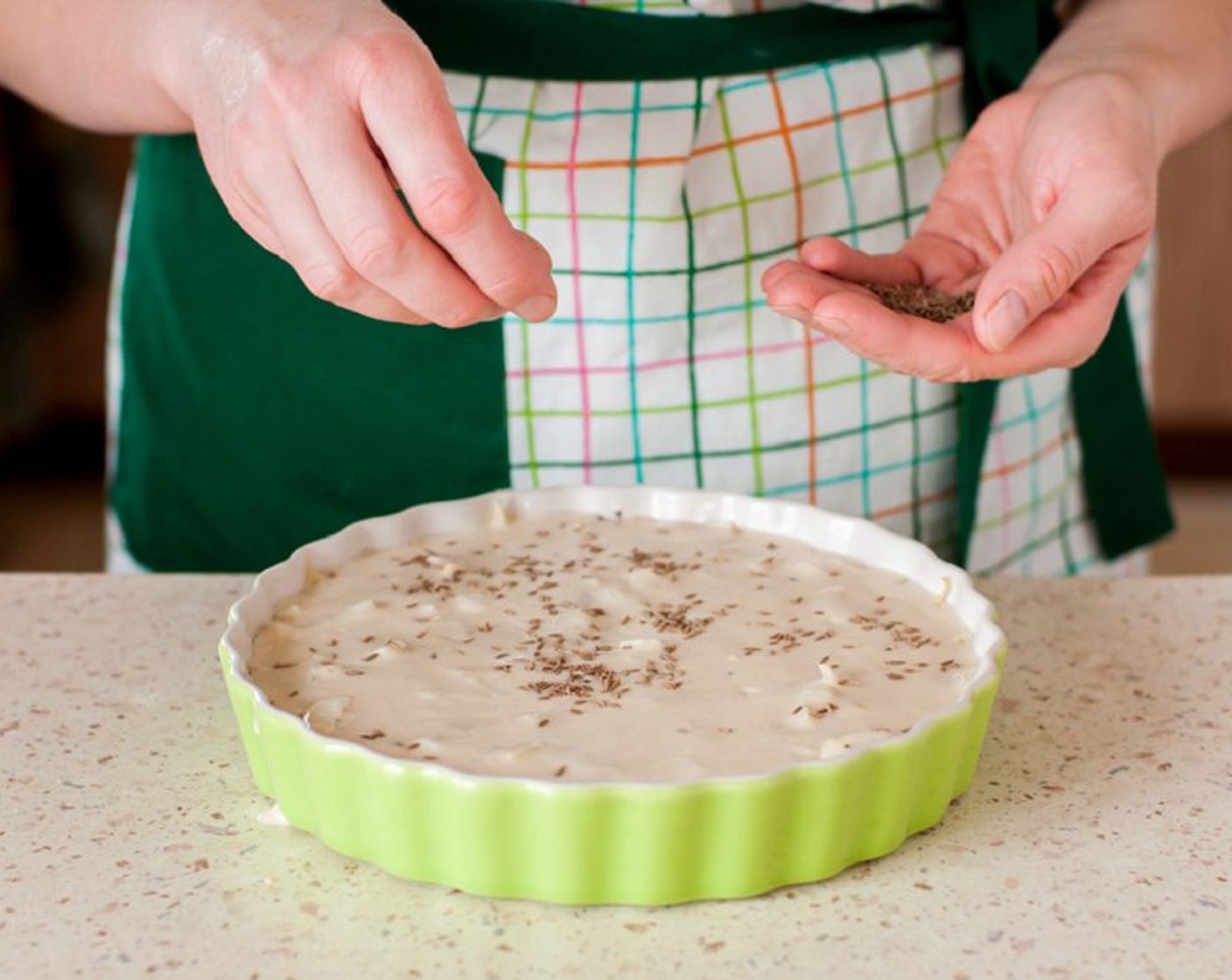 step 7 Now it is time to assemble the pie. Butter the pie plate and pour the batter over the pie and spread. Put the cabbage and egg filling in the pie dish.