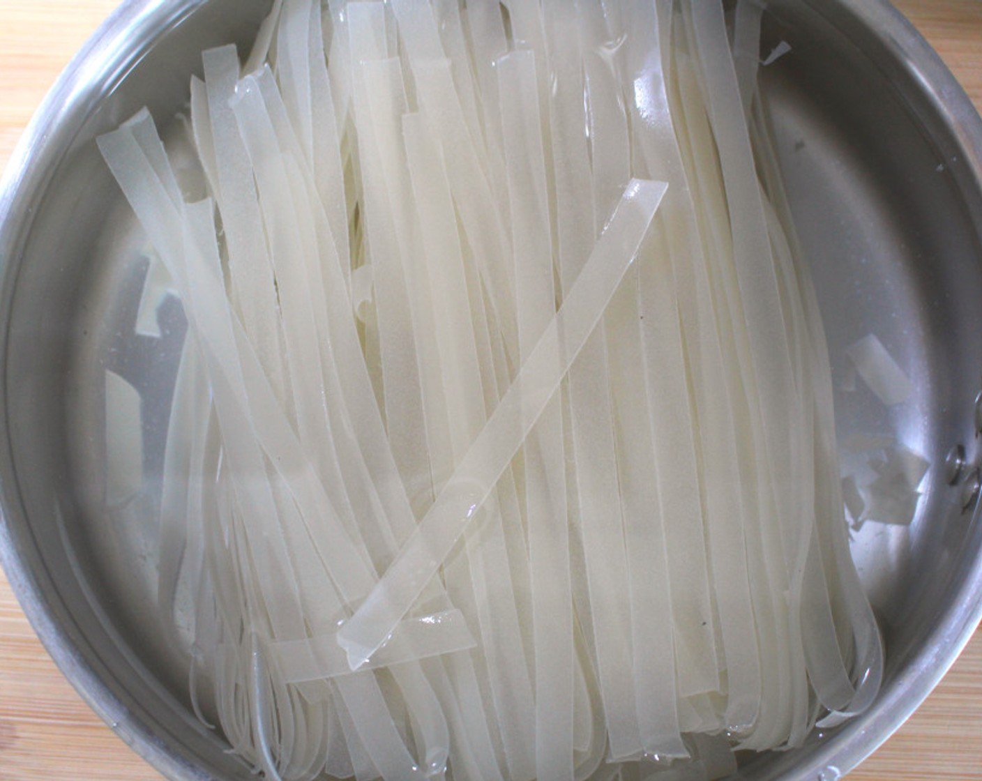 step 7 Cover the Rice Noodles (to taste) with very hot water, let them steep according to the instruction on the packaging.