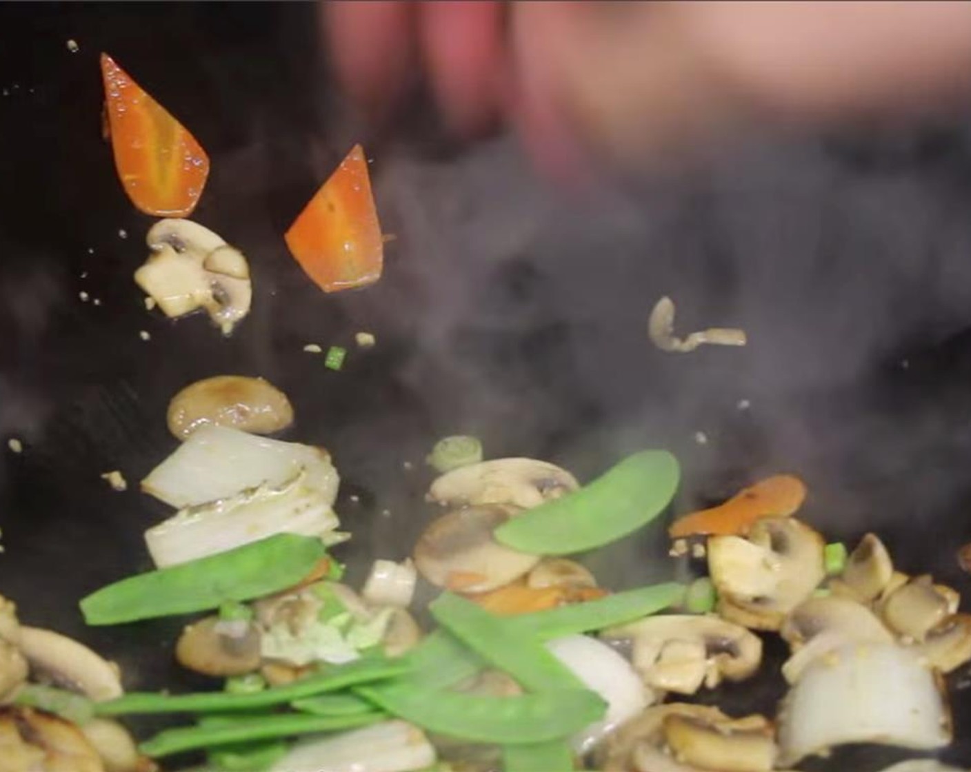 step 13 Then add in minced Garlic (1 clove) and Green Onion roots. Continue to stir fry vegetables for 45 seconds to 1 minute. Then add in the Snow Peas (1/4 cup).