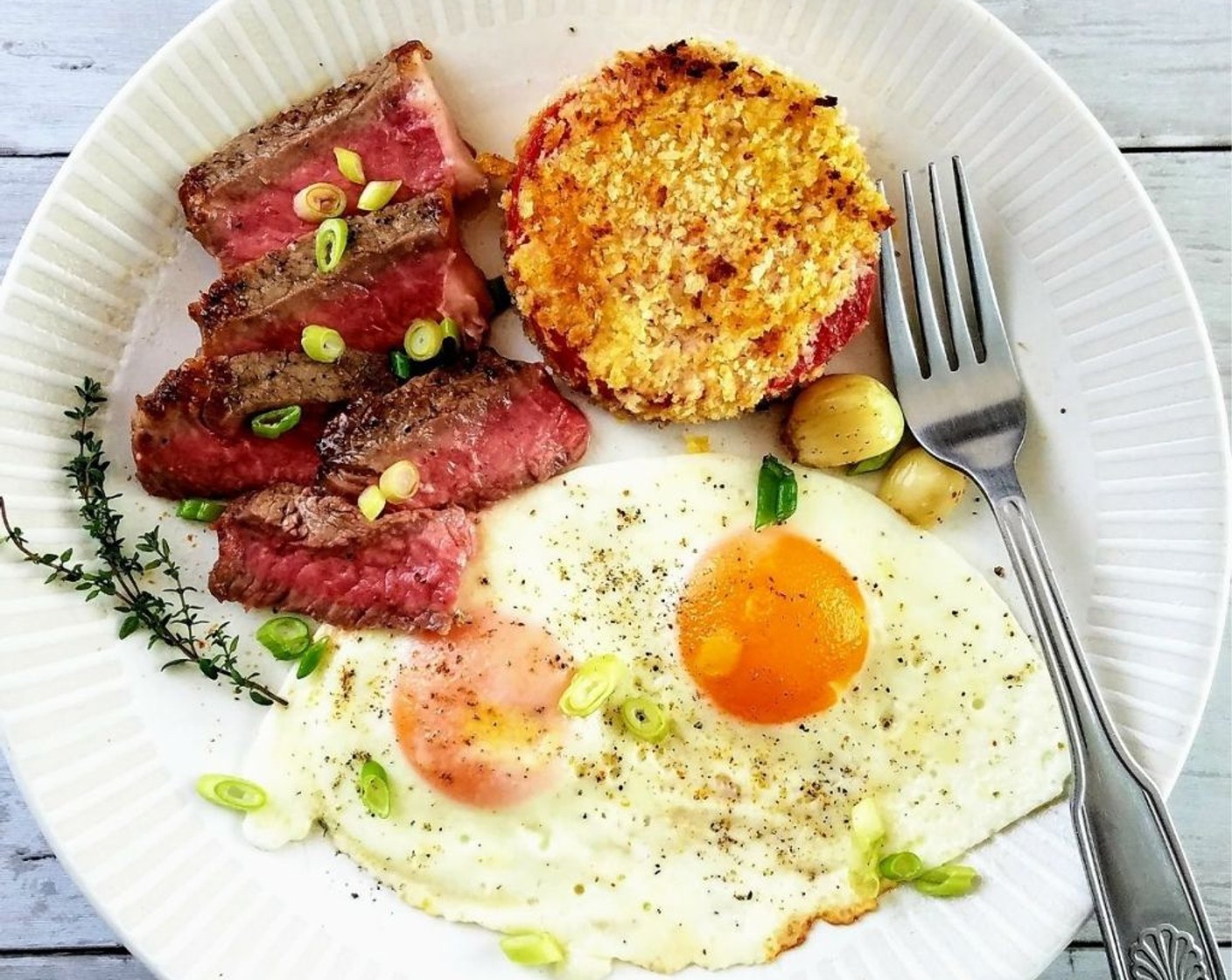 step 10 Slice the sirloin steak and plate alongside the eggs and fried tomatoes. Serve the steak and eggs immediately.
