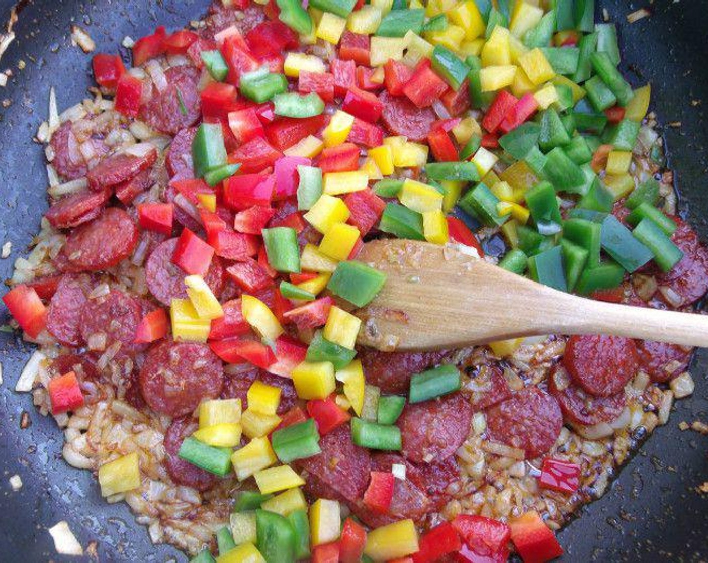 step 6 When the onions are translucent, add Assorted Color Bell Peppers (1 cup) and saute for 1 minute.