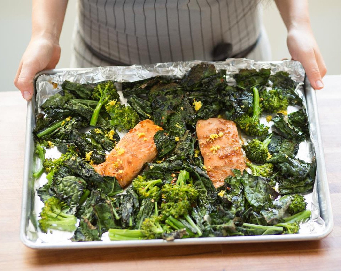 step 8 Nestle the salmon fillets between the kale and broccolini (discard the remaining marinade) and roast in the oven for 8 to 10 minutes, or until the vegetables are tender and the salmon is cooked through.