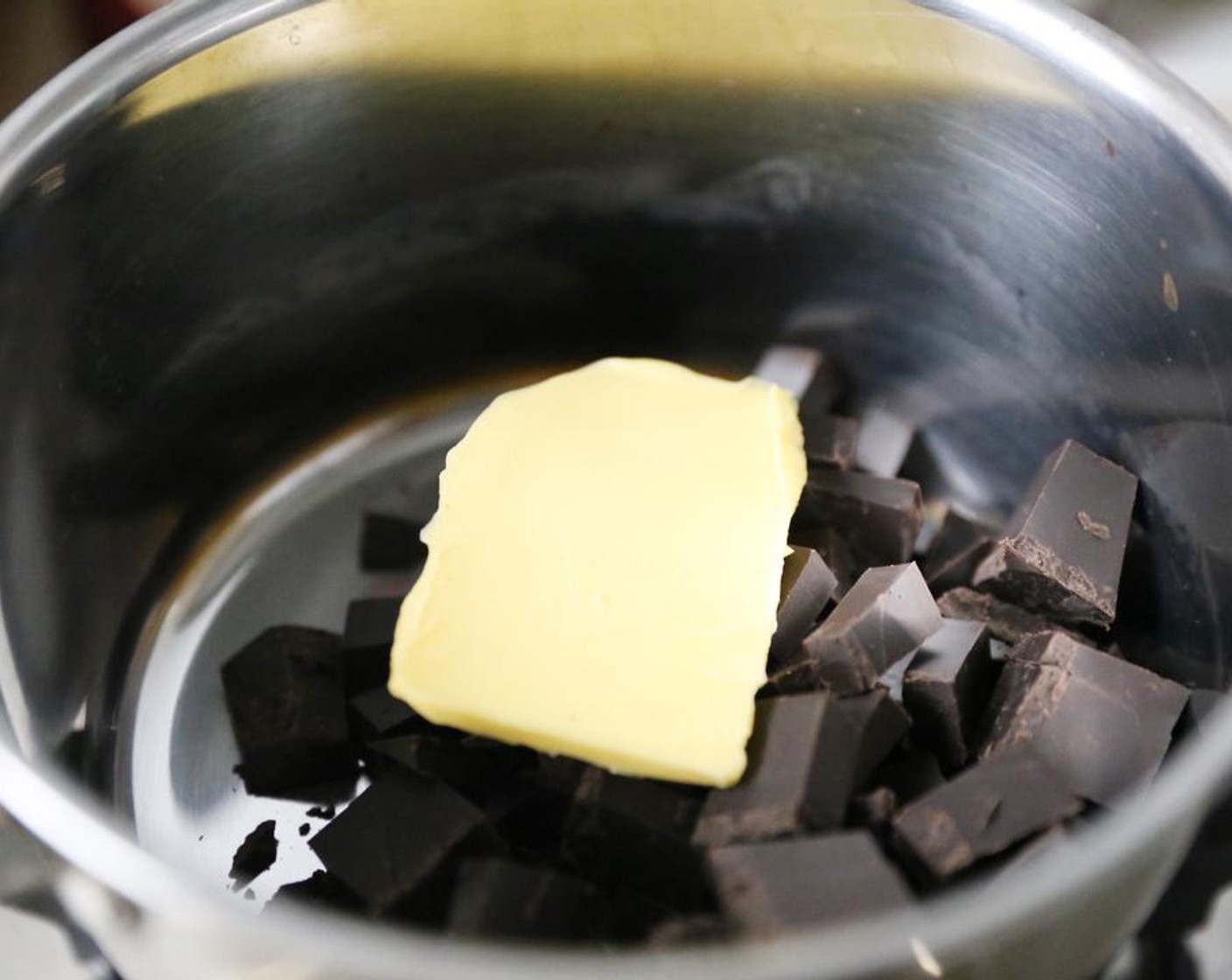 step 1 Combine the Dark Chocolate (1 cup) and Butter (1 1/4 cups) in a small saucepan. Melt over a low heat until smooth.