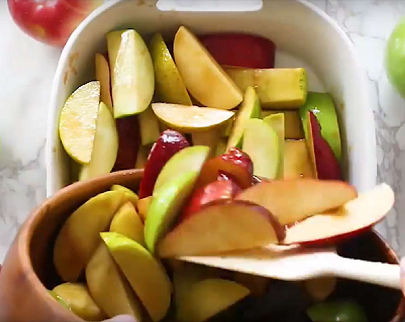 step 4 Next, pour your caramelized sugar over your apples in a bowl. Mix thoroughly, and place apples and caramel in a large casserole dish. Spread out evenly.