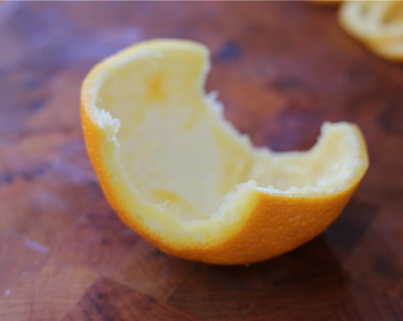 step 2 Cut the remaining orange peel in half lengthwise.