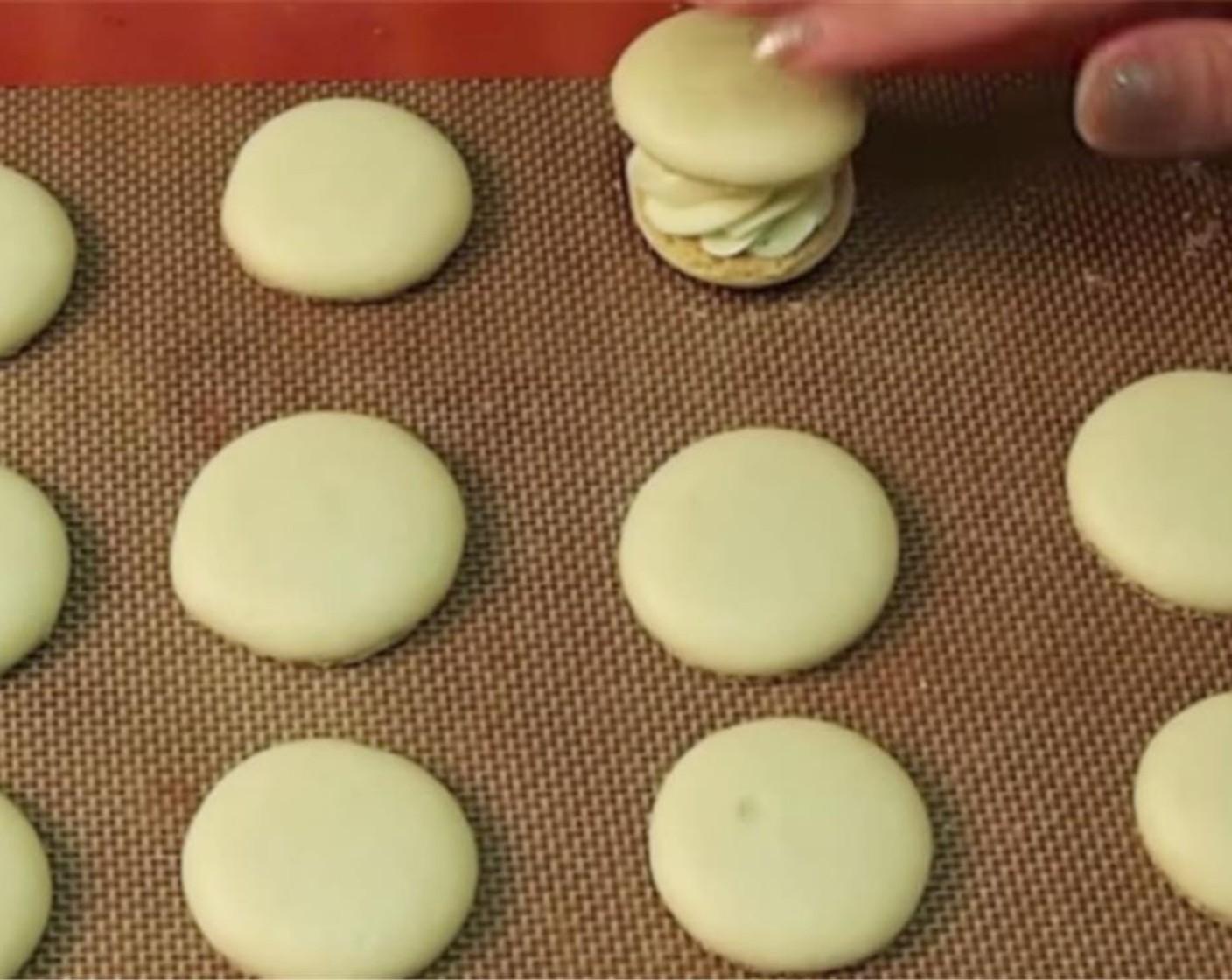 step 12 Place another macaron on top, pressing gently. Repeat until all macaron pairs are combined.