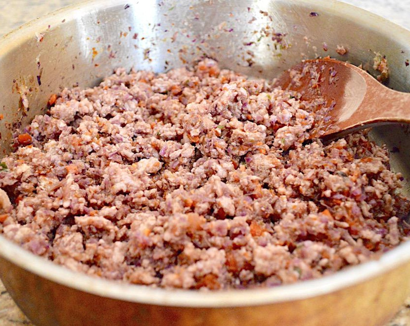 step 2 In a large skillet over medium high heat, heat the Sesame Oil (1 dash). Add the vegetable mixture and let it soften for a minute. Then add in the Ground Pork (8 oz) and break it up as it browns, stirring it thoroughly into the vegetables.