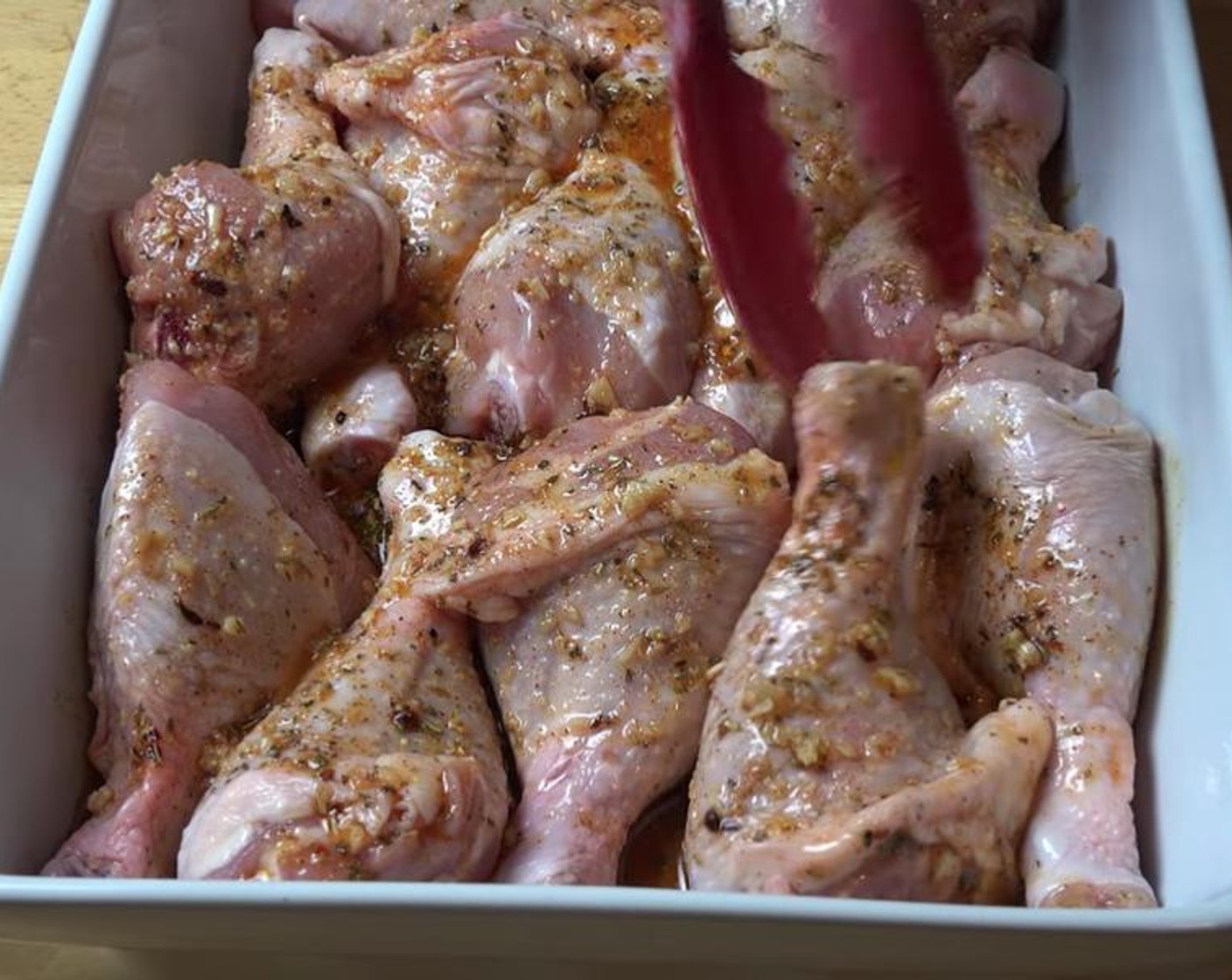 step 2 Place Chicken Drumsticks (12) in an ovenproof roasting dish. Carefully pour marinade over the chicken. Using tongs, flip the chicken pieces to coat on all sides.