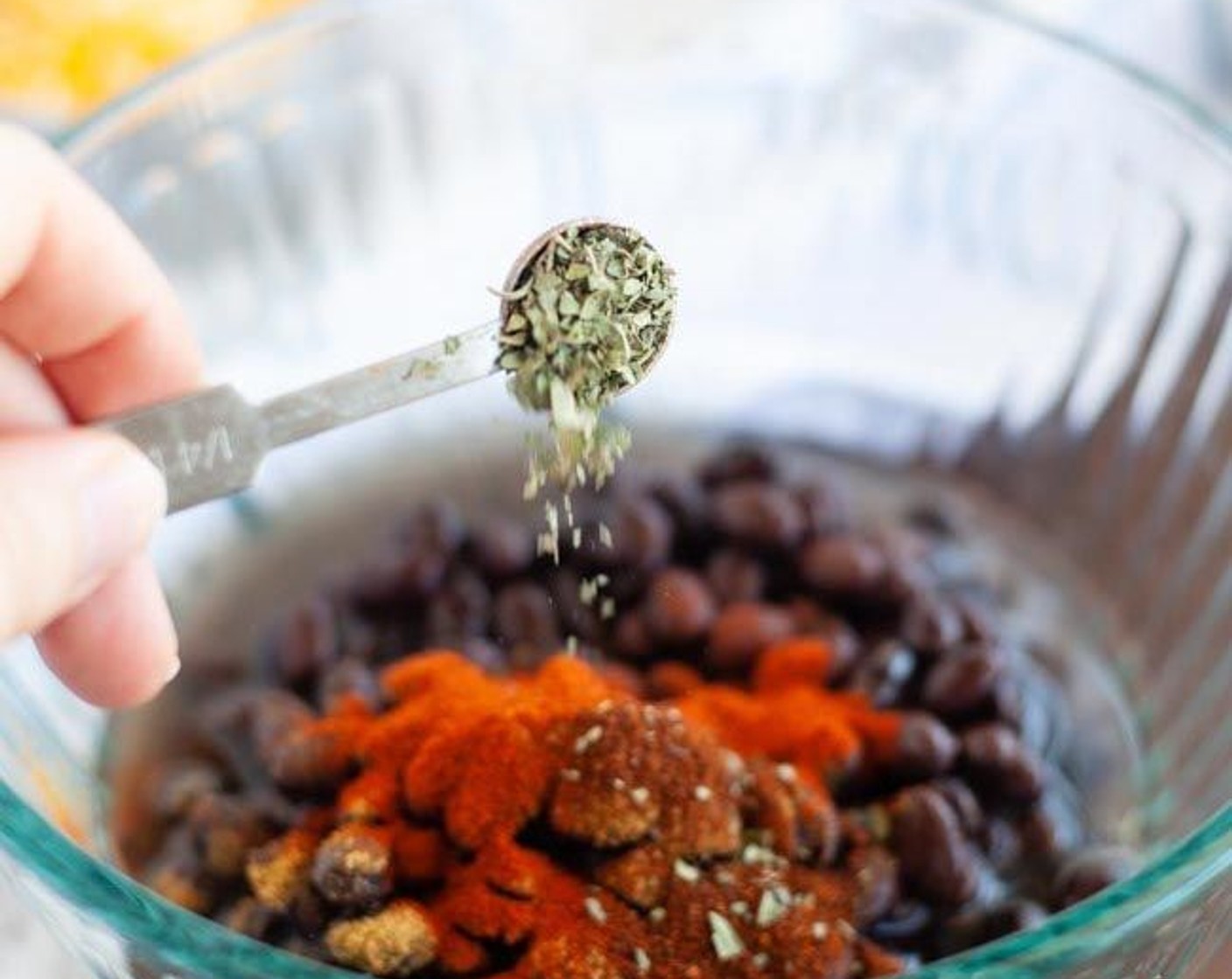 step 1 In a medium microwave-safe bowl pour in the Black Beans (1 can), Water (1/4 cup), Ground Cumin (1 tsp), Smoked Paprika (1 tsp), Chili Powder (1/2 tsp), Cayenne Pepper (1/4 tsp) and Dried Oregano (1/4 tsp). Season with Sea Salt (to taste) and Ground Black Pepper (to taste) and stir to combine.