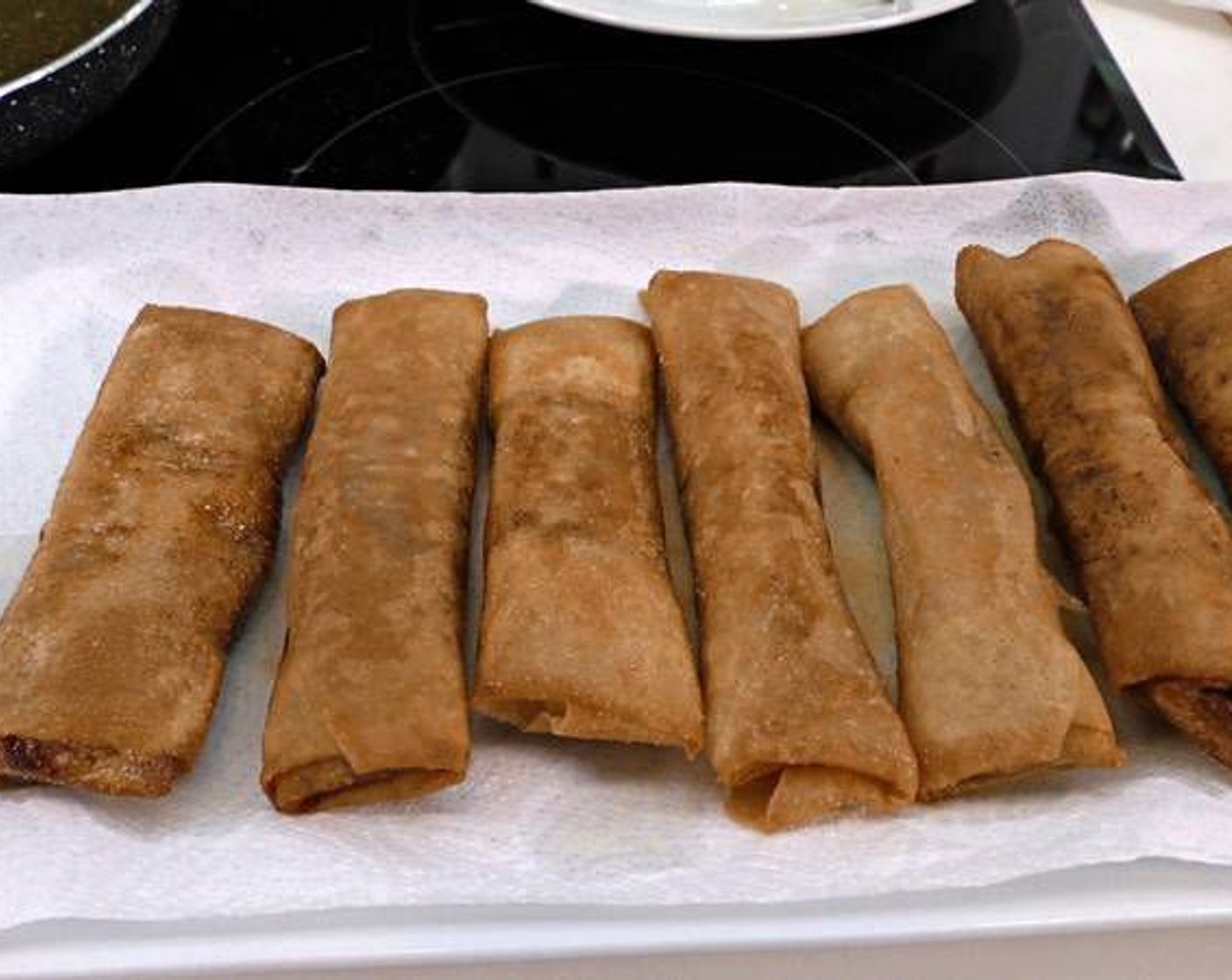 step 15 Once the spring rolls are golden brown and crispy, remove them and place on a paper towel to absorb the excess oil.