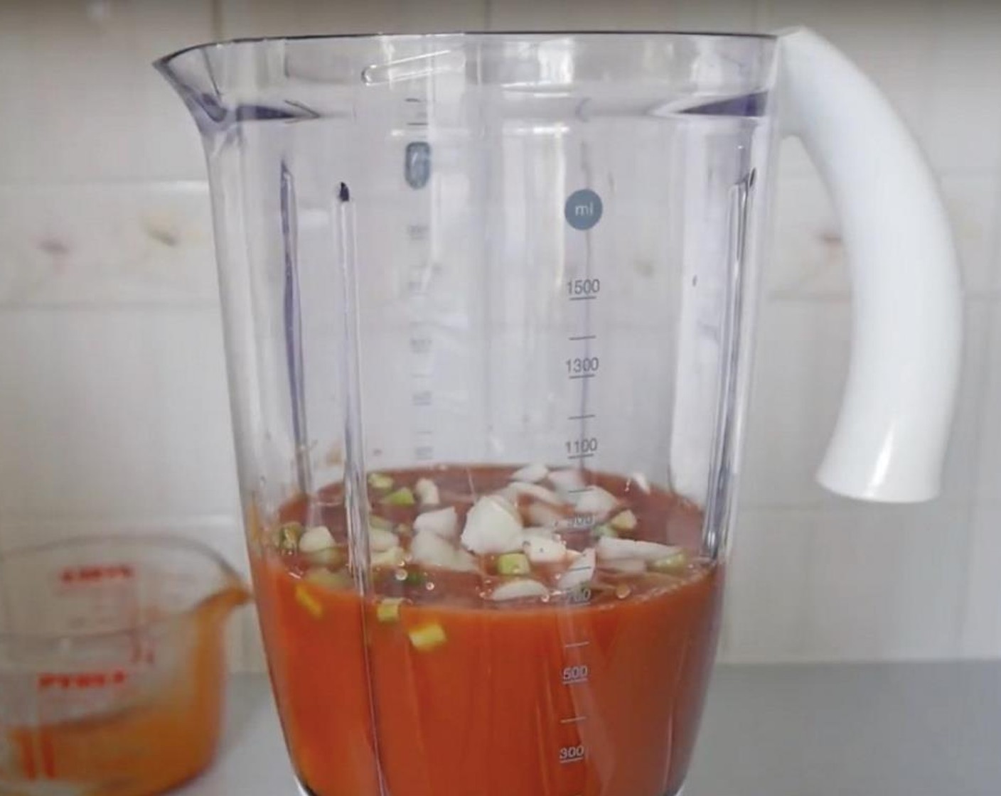step 2 In the meantime, in a blender, blitz the Tomato Passata (2 cups), Scallion (1 bunch), Onion (1), Garlic (4 cloves), Red Chili Pepper (1/2), and Green Bell Pepper (1/2).