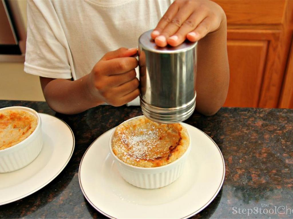 Step 14 of Simple Vanilla Soufflé Recipe: Sprinkle the tops of the soufflés with Powdered Confectioners Sugar (to taste).