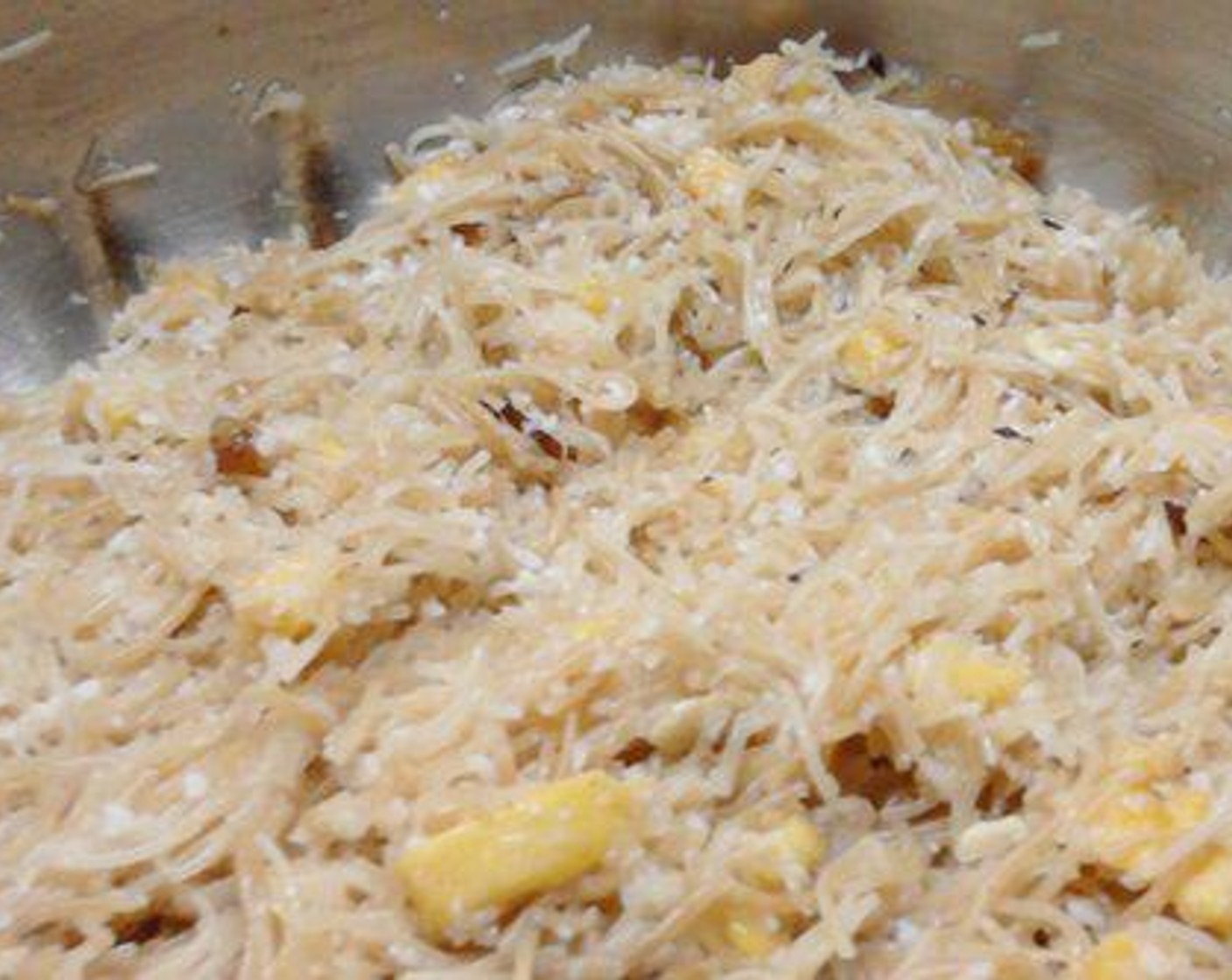 step 1 Cook the Vermicelli Noodles (7 oz) adding Water (to taste). To this add Coconut (1 cup), Cashew Nuts (1 Tbsp), Raisins (1 Tbsp), Bananas (2), Caster Sugar (1/4 cup), Ground Cardamom (1/2 tsp), and All-Purpose Flour (2 Tbsp). Mix well