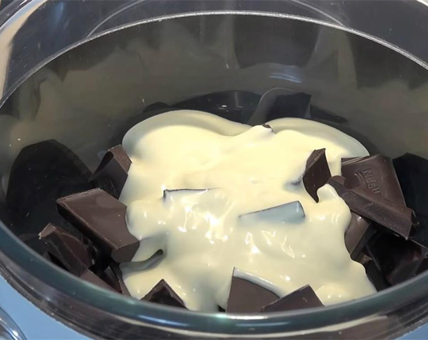 step 1 In a heat-safe bowl over simmering hot water, melt and combine Semi-Sweet Dark Chocolate (2 1/4 cups) and Whipping Cream (2/3 cup) to make the ganache.