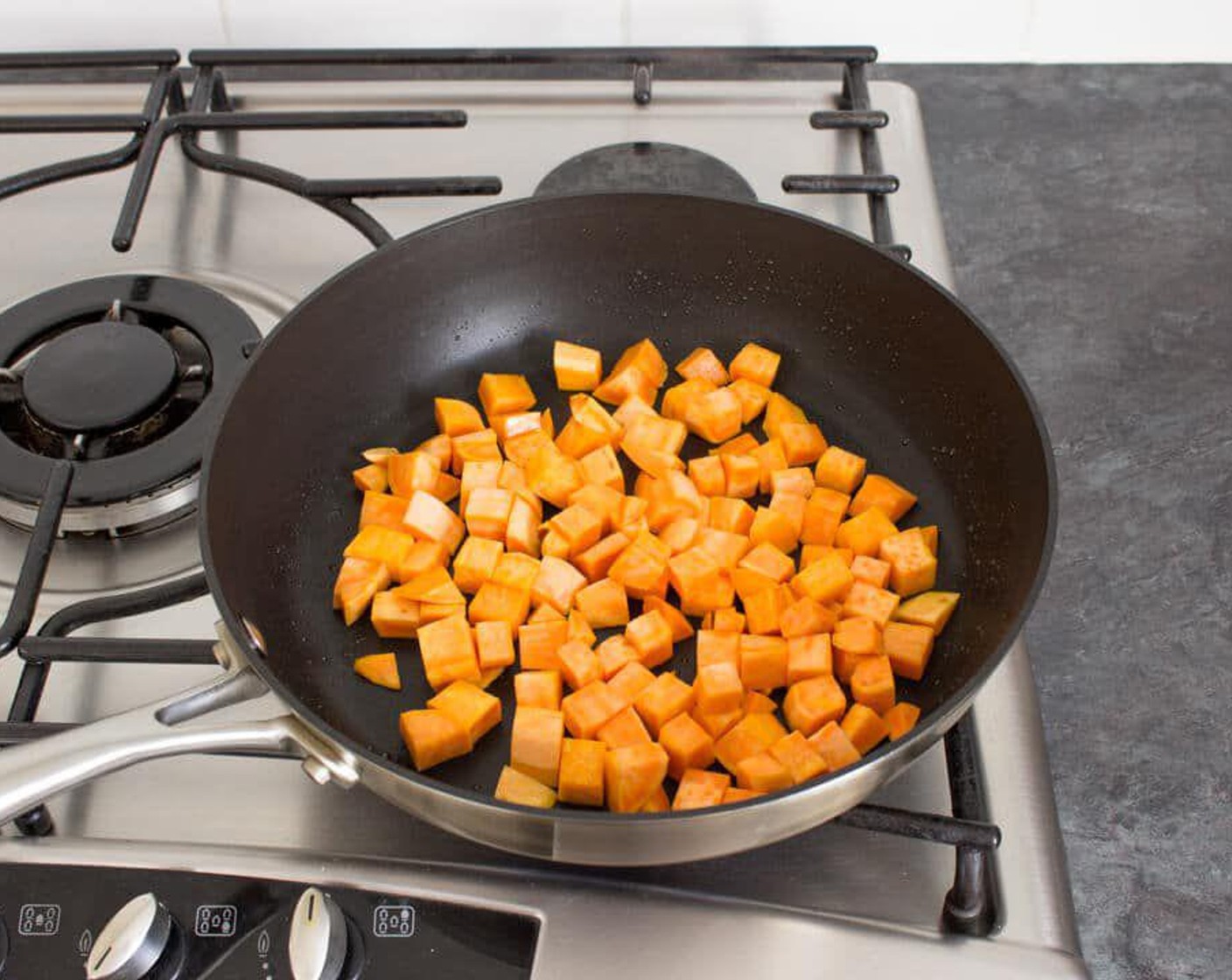 step 1 Heat a large, non stick frying pan over a medium heat. Add in the Olive Oil (1 Tbsp), swill around the pan a little then throw in Sweet Potato (1). Cook for 2 – 3 minutes.