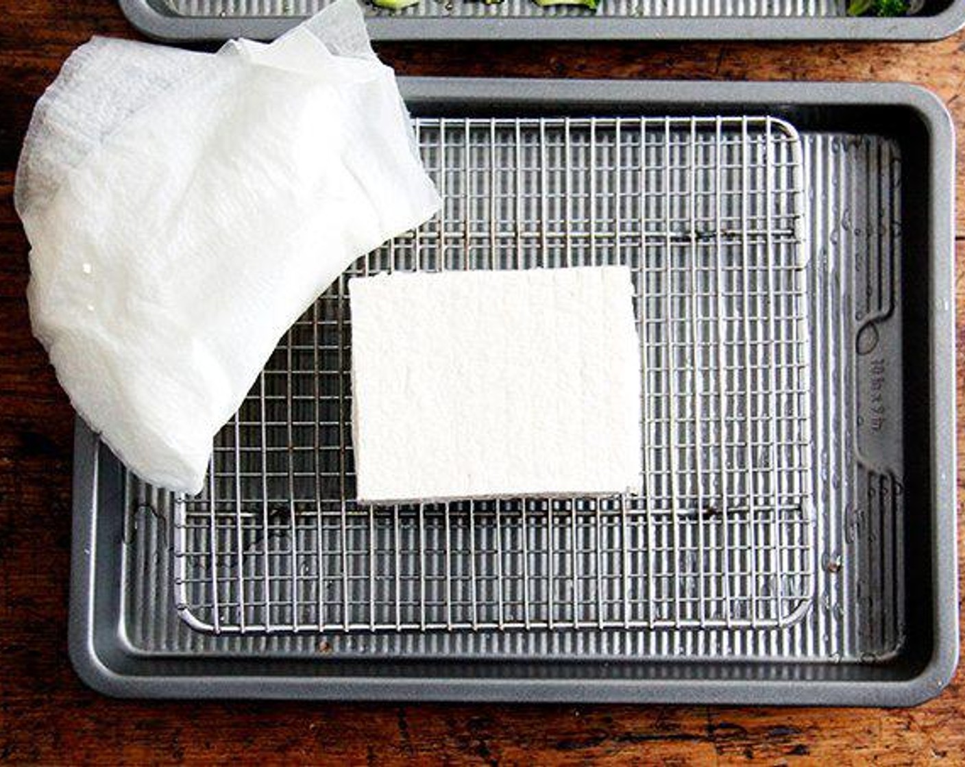 step 1 Prepare the tofu: Drain the Extra Firm Tofu (1 block) and place it on a few paper towels; place a few more towels over it. Place a heavy object—like a big frying pan—over the tofu, and let it rest for 10 minutes (and up to 30, if you have the time) to press out the excess liquid.