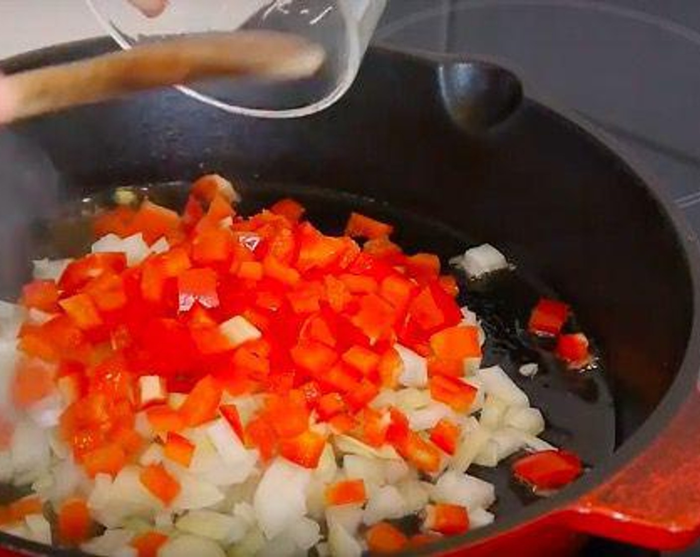 step 2 The first thing we need to do is a classic sofrito so we cook in a hot pan with some Olive Oil (as needed) or vegetable oil the Red Chili Pepper (1) and White Onion (1).