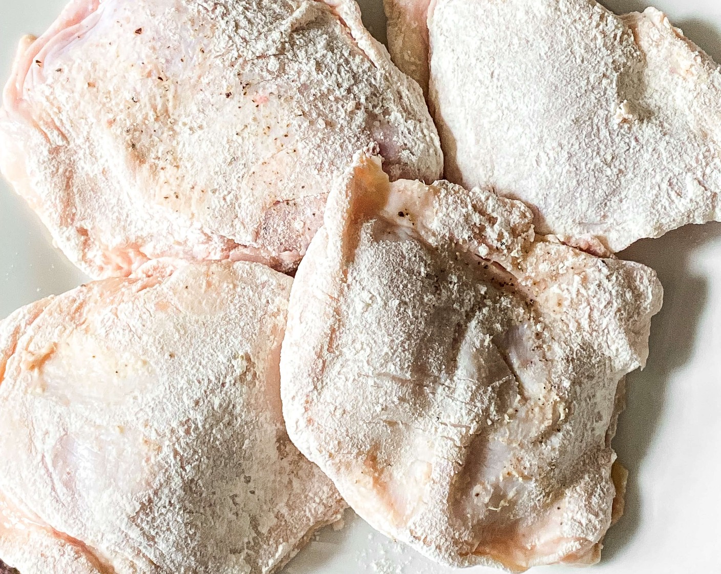 step 1 Season Bone-in, Skin-on Chicken Thighs (1.5 lb) with Salt (to taste), and Ground Black Pepper (to taste). Add All-Purpose Flour (1/2 cup) to a small bowl and dip chicken thighs in to coat with flour. Shake off excess flour.