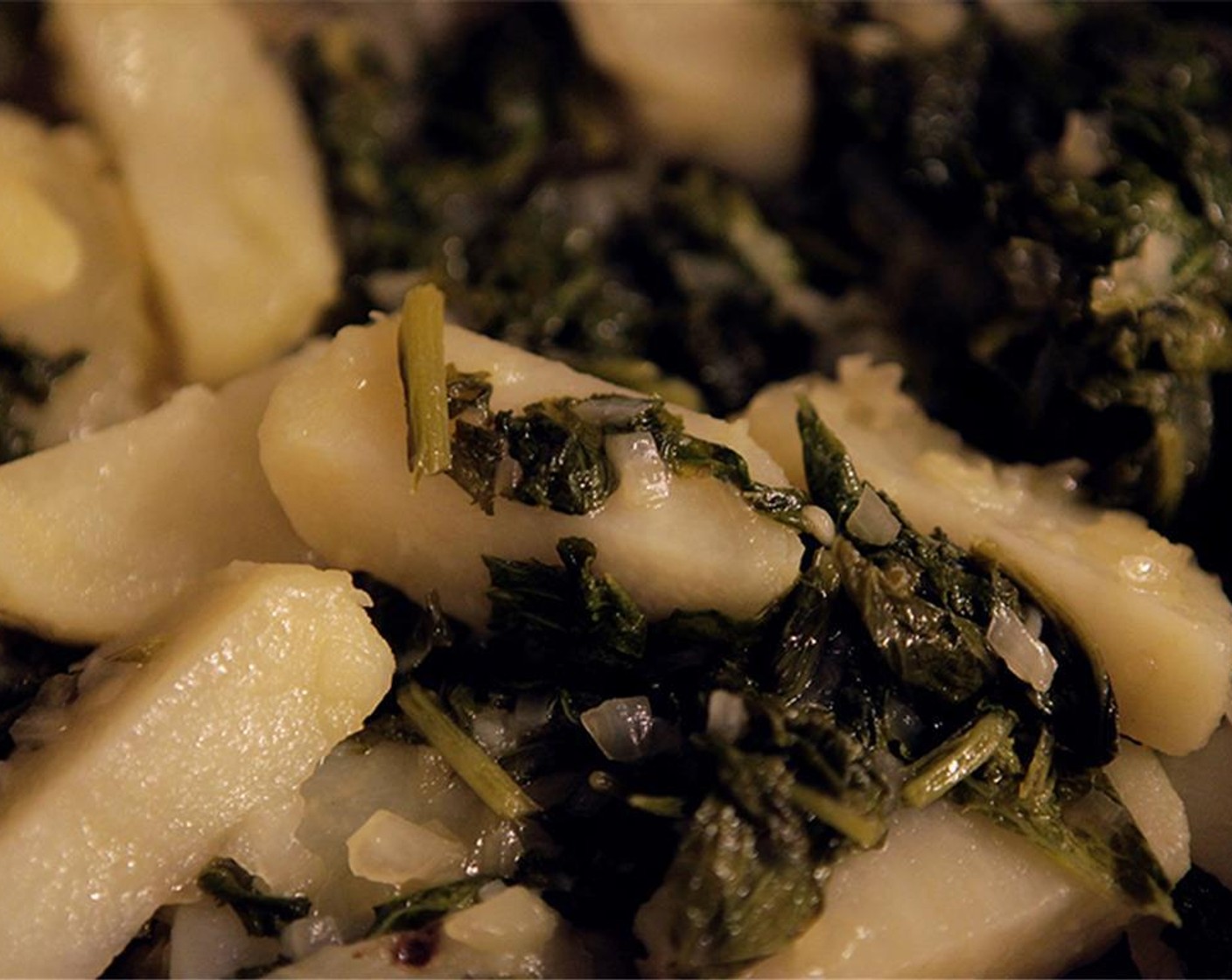 step 5 Once the potato is cool, peel and slice into 1/2-inch thick half-moons. Add the potatoes to the kale, and heat through. Season to taste with Kosher Salt (to taste) and Ground Black Pepper (to taste) and set aside to be served warm.