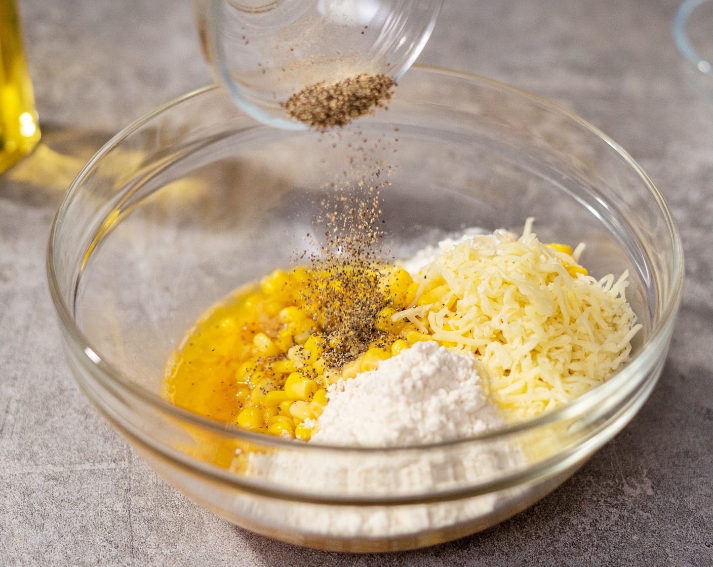 step 2 In a large mixing bowl, combine Corn (1 can), Egg (1), All-Purpose Flour (1/4 cup), Shredded Mozzarella Cheese (1/4 cup), Butter (1 Tbsp), Baking Powder (1/2 tsp), Ground Black Pepper (1/2 tsp), and Salt (1/4 tsp). Let it sit in the fridge for 20 minutes up to overnight.