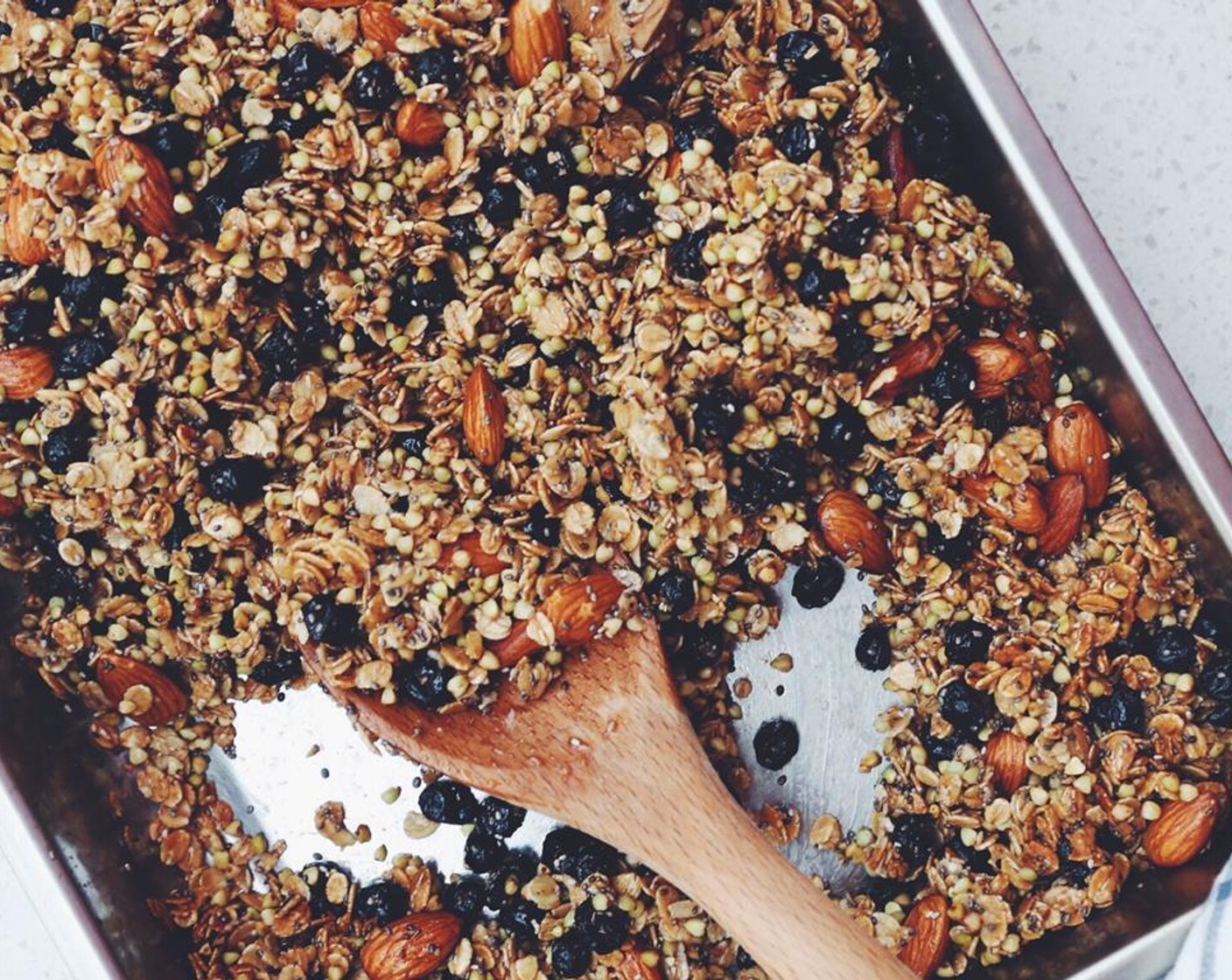 step 6 Using a spatula, toss the mixture and bake another 8 to 10 minutes or until the granola just begins to color.