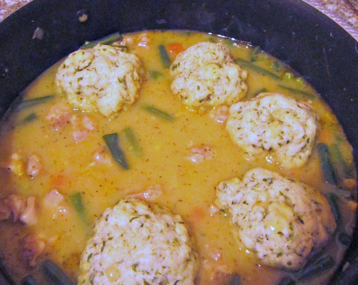 step 9 Gently drop dumpling balls on top of your stew, then cover and cook for 12 minutes until dumplings fluff up and are cooked through. Don't take the lid off while they're cooking!