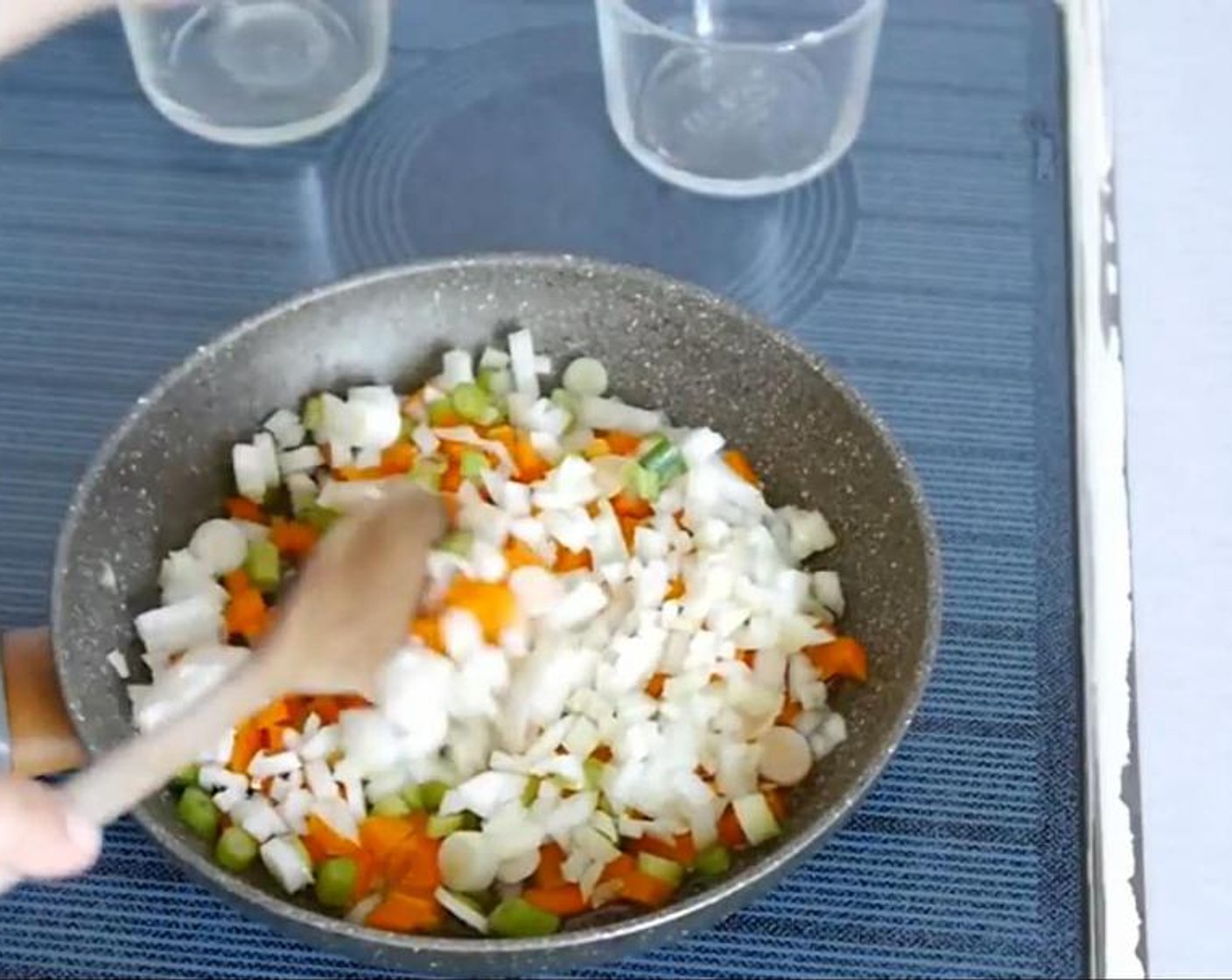 step 1 To a hot pan add the Vegetable Oil (4 Tbsp), Onion (1), and Bell Pepper (1) stir and leave to cook until soften