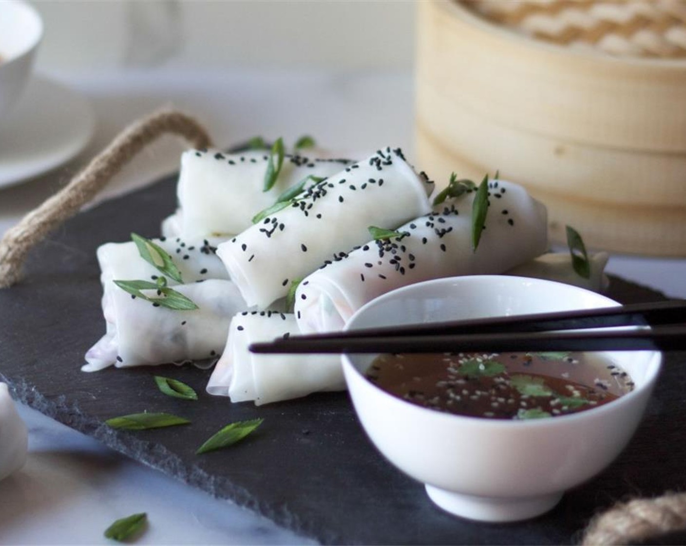 step 8 When ready to serve, sprinkle the spring rolls with a scattering of toasted Black and White Sesame Seeds (2 Tbsp), Scallions (to taste) and dunk into the ice-cold dipping sauce. Enjoy!