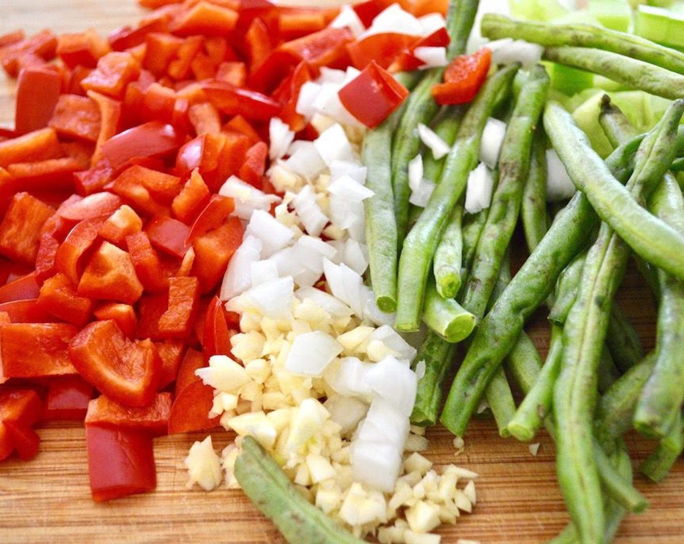 step 3 Then add the Green Beans (1/2 cup), Garlic (6 cloves), Onion (1), Red Bell Pepper (1), and Celery (2 stalks) to the pan. Let them cook and get fragrant for a couple of minutes in the wine. Stir the chicken and sausage back in.