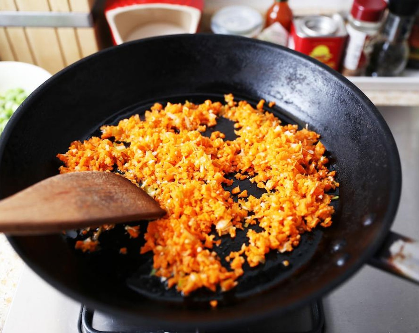 step 3 Heat the Sesame Oil (2 Tbsp) in a wok over a low heat and add the carrot, garlic and scallion mixture. Stir fry until fragrant, about 5 minutes.