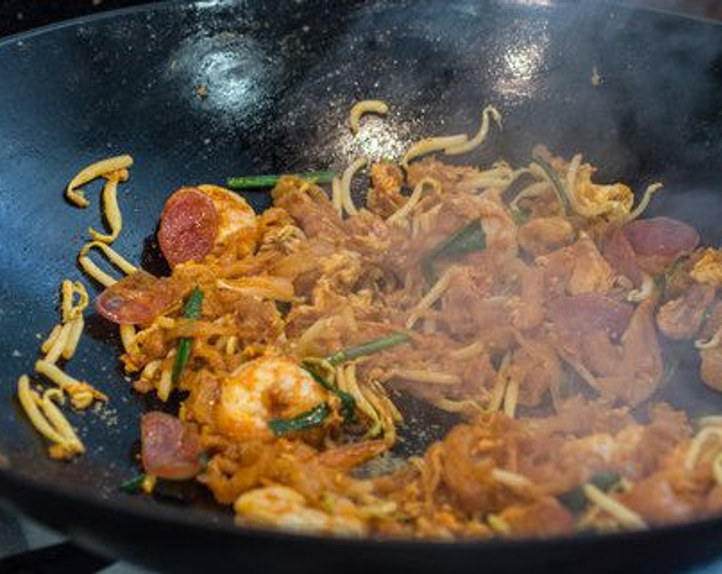 step 7 Stir to combine just for a few seconds, then dish it out on to a serving plate lined with a Banana Leaves (to taste) with Red Chili Peppers (to taste).