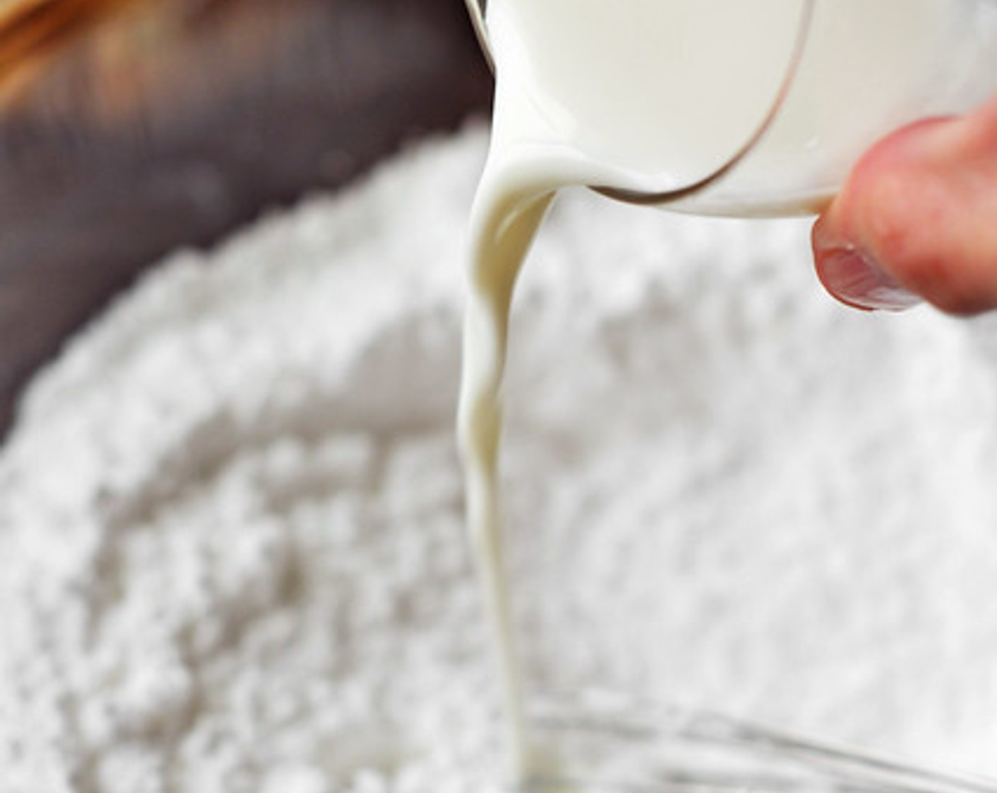 step 14 To make the glaze, mix the Powdered Confectioners Sugar (4 cups), Rum (1 Tbsp), and whole Milk (3 Tbsp) in a bowl. As you whisk, stream in the Fresh Pineapple Juice (3 Tbsp), a tablespoon at a time. Whisk until the glaze is thick, but still pourable.