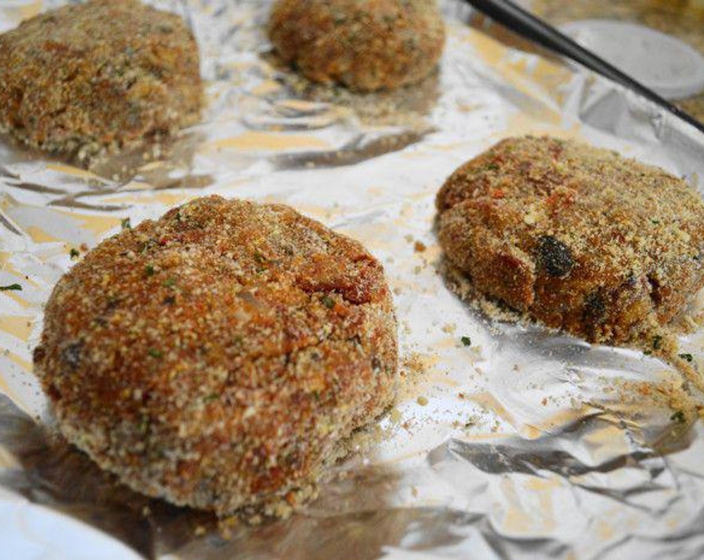 step 6 Divide the mixture into quarters, and then form each quarter into a ball. Coat the four Italian veggie cakes in breadcrumbs, place them on the prepared baking sheet and flatten them lightly into patties. Bake the Italian veggie cakes in the oven for about 15 minutes, until golden and completely cooked through.