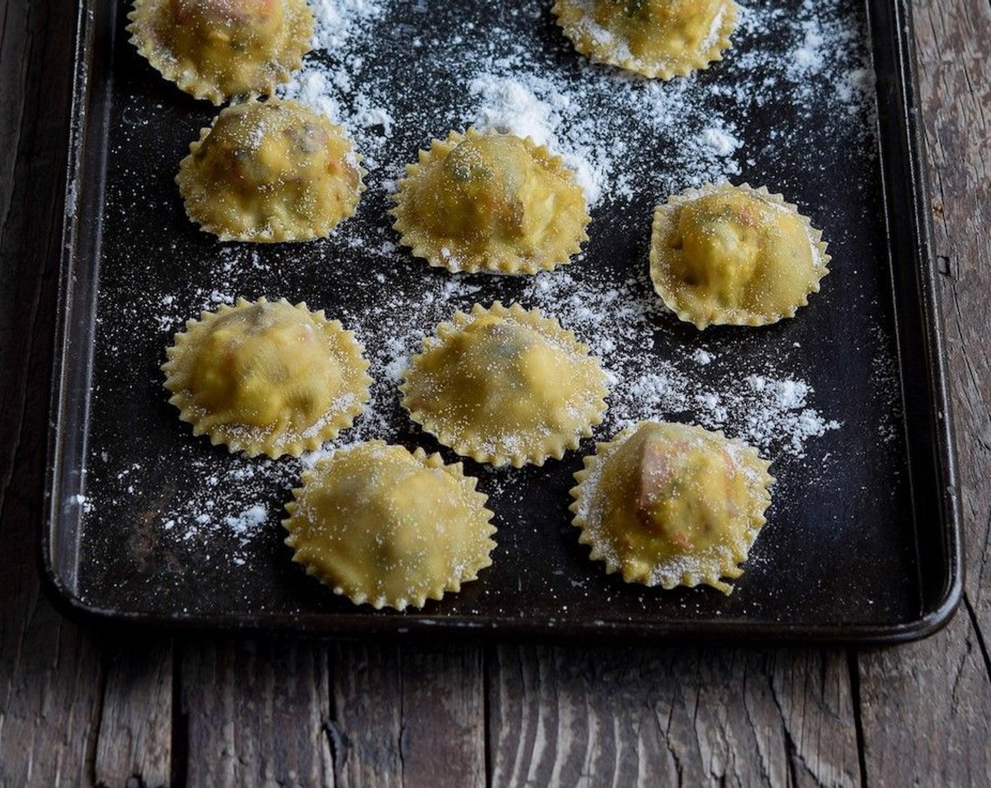 step 10 Roll out the remaining pasta and gently drape over the pumpkin dollops, cupping your hand around each pocket to press out any air. Press down on the edges and cut around the filling, then seal the edges of the ravioli pockets with a brush of water.