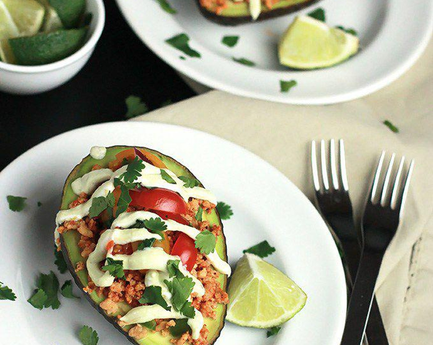 step 5 Scoop two heaping tablespoons full of the textured vegetable protein into each avocado, spoon some of the tomatoes and avocado cream over the vegetable protein, and garnish with more Fresh Cilantro (to taste) and Lime (1). Enjoy!