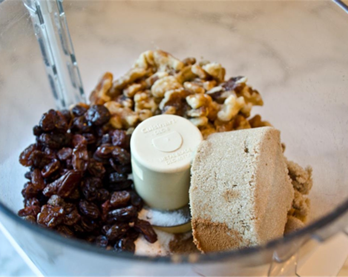 step 5 To make the filling, place the Brown Sugar (1/2 cup), Granulated Sugar (2 Tbsp), Walnut (1 cup), Raisins (1/2 cup) and Ground Cinnamon (1 Tbsp) in the bowl of the food processor and pulse until the walnuts and raisins are finely chopped. Transfer to a bowl and set aside until the dough is ready.