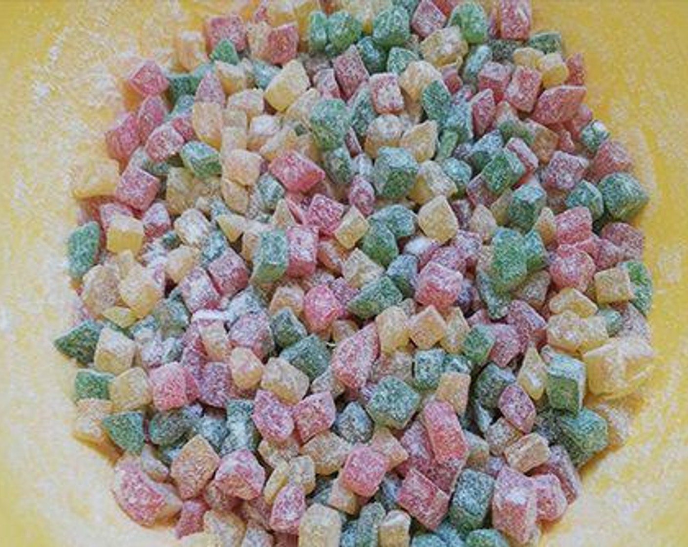 step 1 Add Tutti Frutti Candy (1 cup) to a bowl. Reserve a few to sprinkle on top before baking. Add All-Purpose Flour (4 Tbsp). Mix well and set aside.