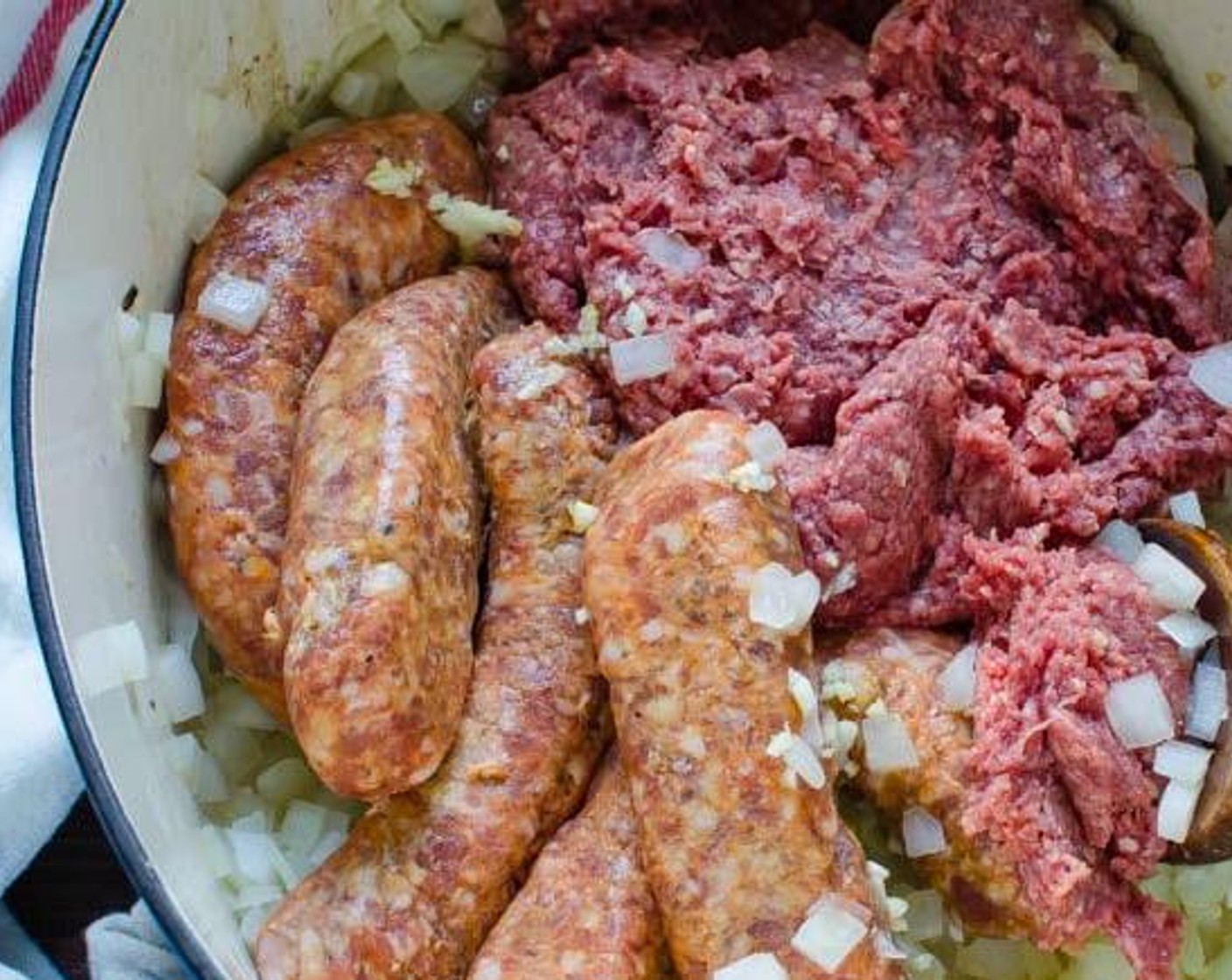 step 2 In a dutch oven, heat Olive Oil (1 Tbsp) over medium heat. Add the chopped onion and sauté for 3-4 minutes, until translucent. Add Italian sausage and Extra Lean Ground Beef (1 lb) and break meat apart using a wooden spoon or fork.