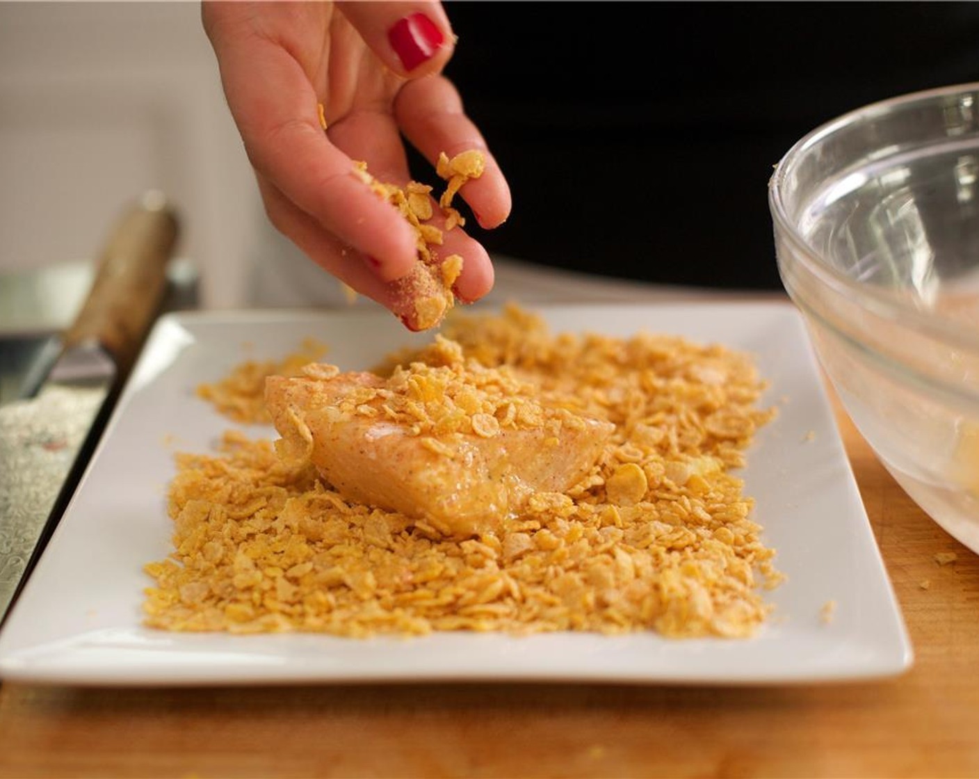 step 13 Dredge the cod in the flour, then dip into the egg wash, and finally into the cornflake crumbs, pressing the crumbs into the fish to ensure even coverage. Place fish onto another sheet pan and bake for 15 minutes.