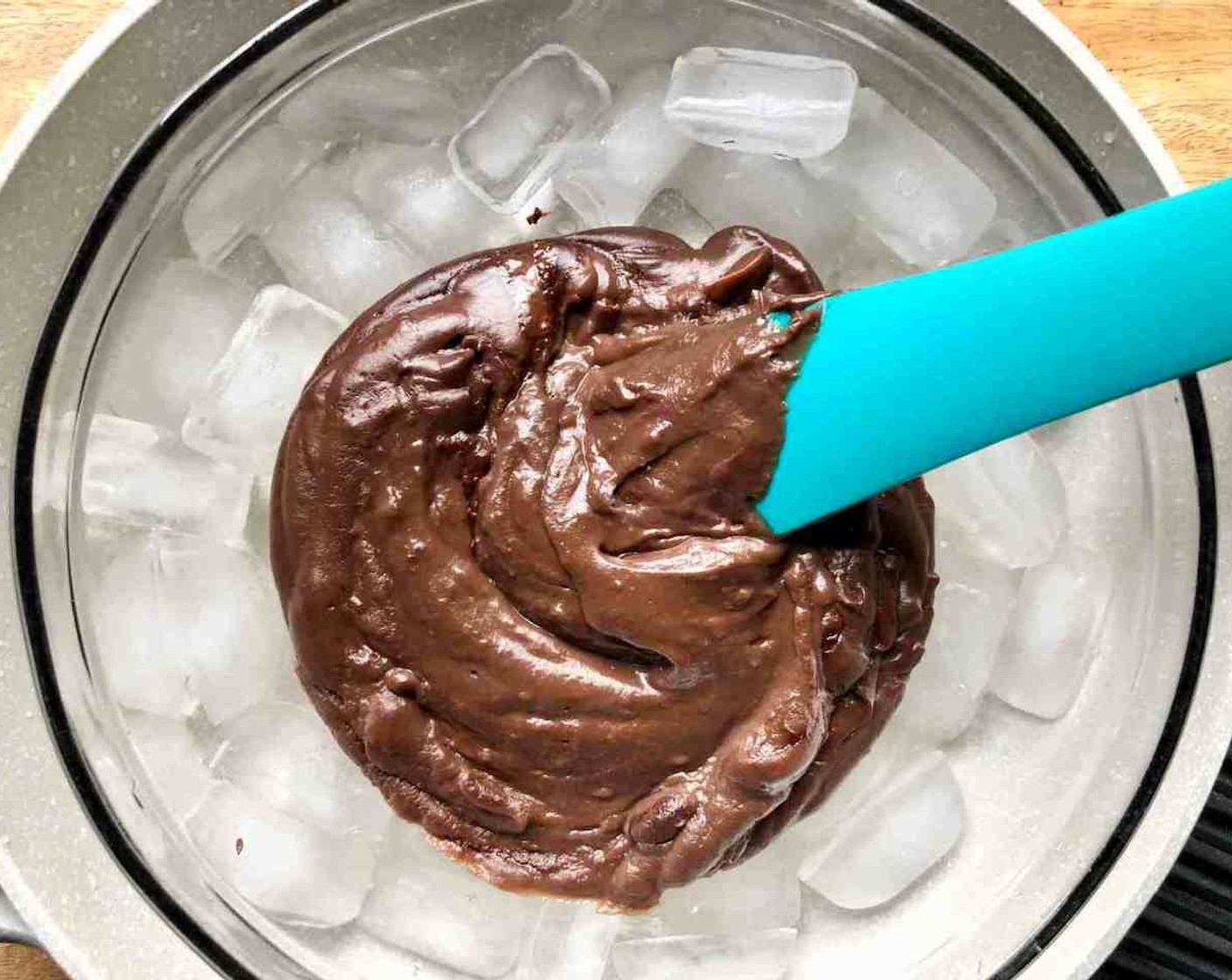 step 9 Transfer the chocolate filling back to the large mixing bowl and place the bowl in a larger ice-filled bowl or pan to hasten the chilling process.