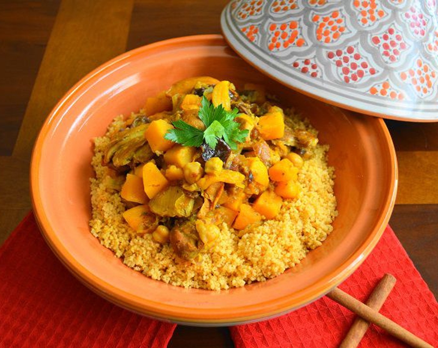 step 12 Scoop the couscous into pretty bowls and ladle a generous portion of the Moroccan chicken over it. Garnish with Fresh Parsley (to taste) and serve immediately! This can also be served family style in a pretty tagine.
