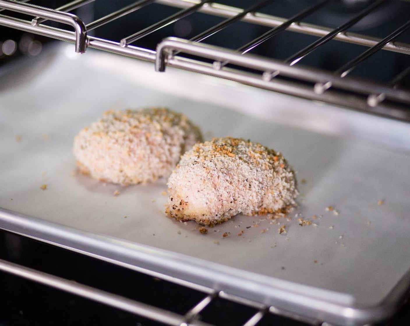 step 9 Place the chicken on a sheet pan lined with parchment paper and bake for 22 to 24 minutes. Remove from oven and keep warm for plating.