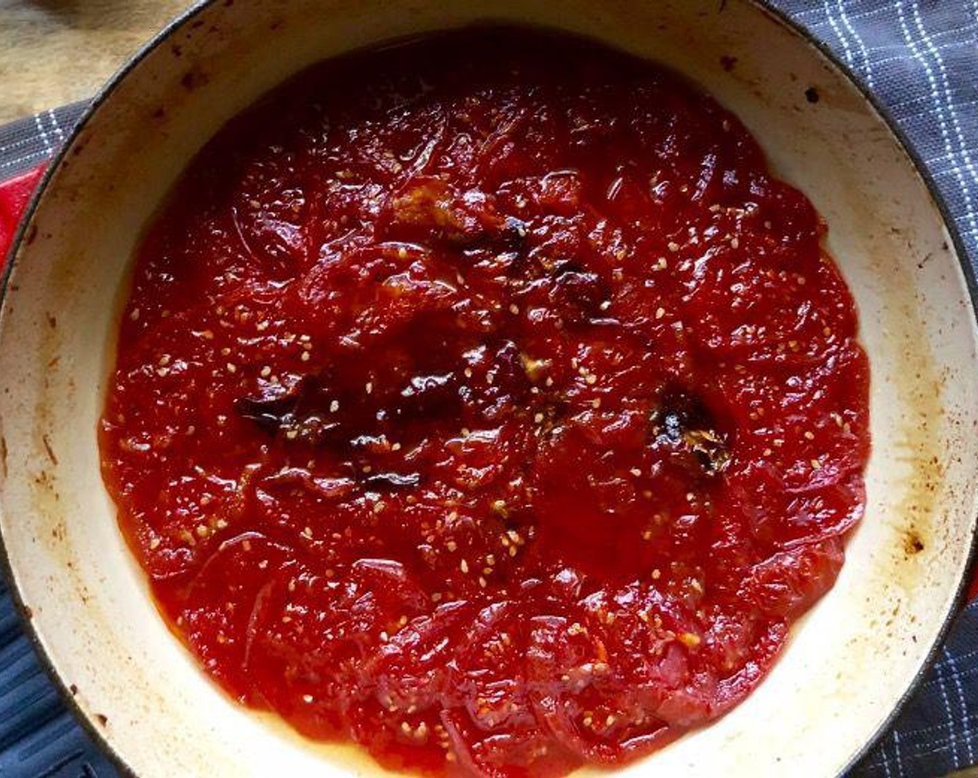 step 5 Place the pan uncovered in the oven for a total of about 2 hours. Before long, the tomato juices should simmer actively. After 1 hour, check to be sure the tomatoes don't appear to be dry on the top layer. If so, baste with the juices that have formed. Continue to check every 20 minutes, spooning the juices over the top tomatoes as needed. Remove the chiles if they char.