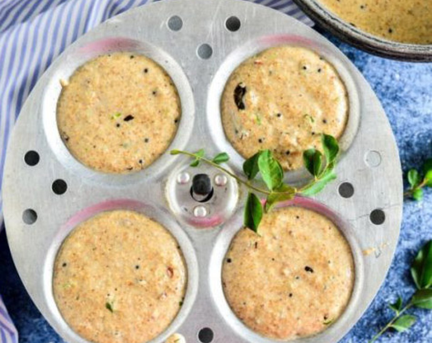 step 9 Pour the batter onto each section and steam the Idlis in a steamer for 12-15 minutes.